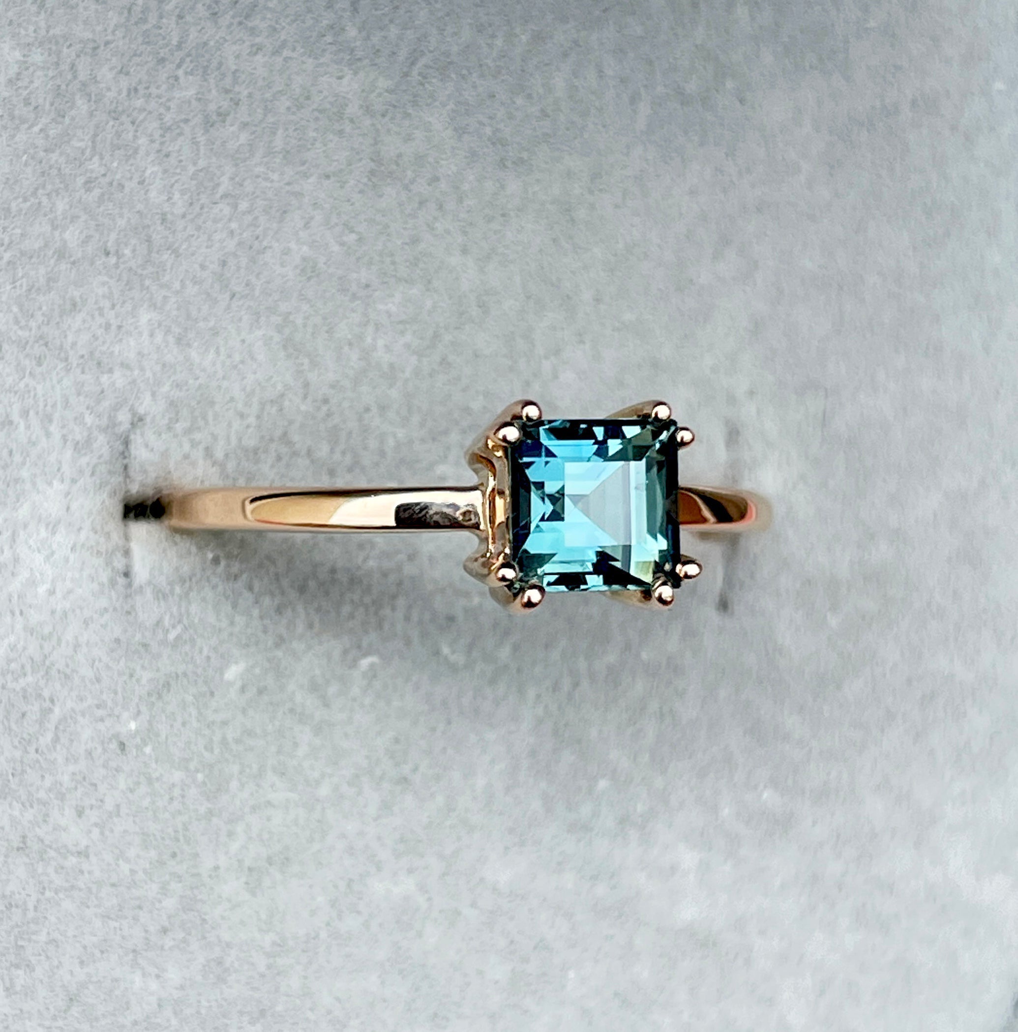 teal sapphire ring in natural sunlight
