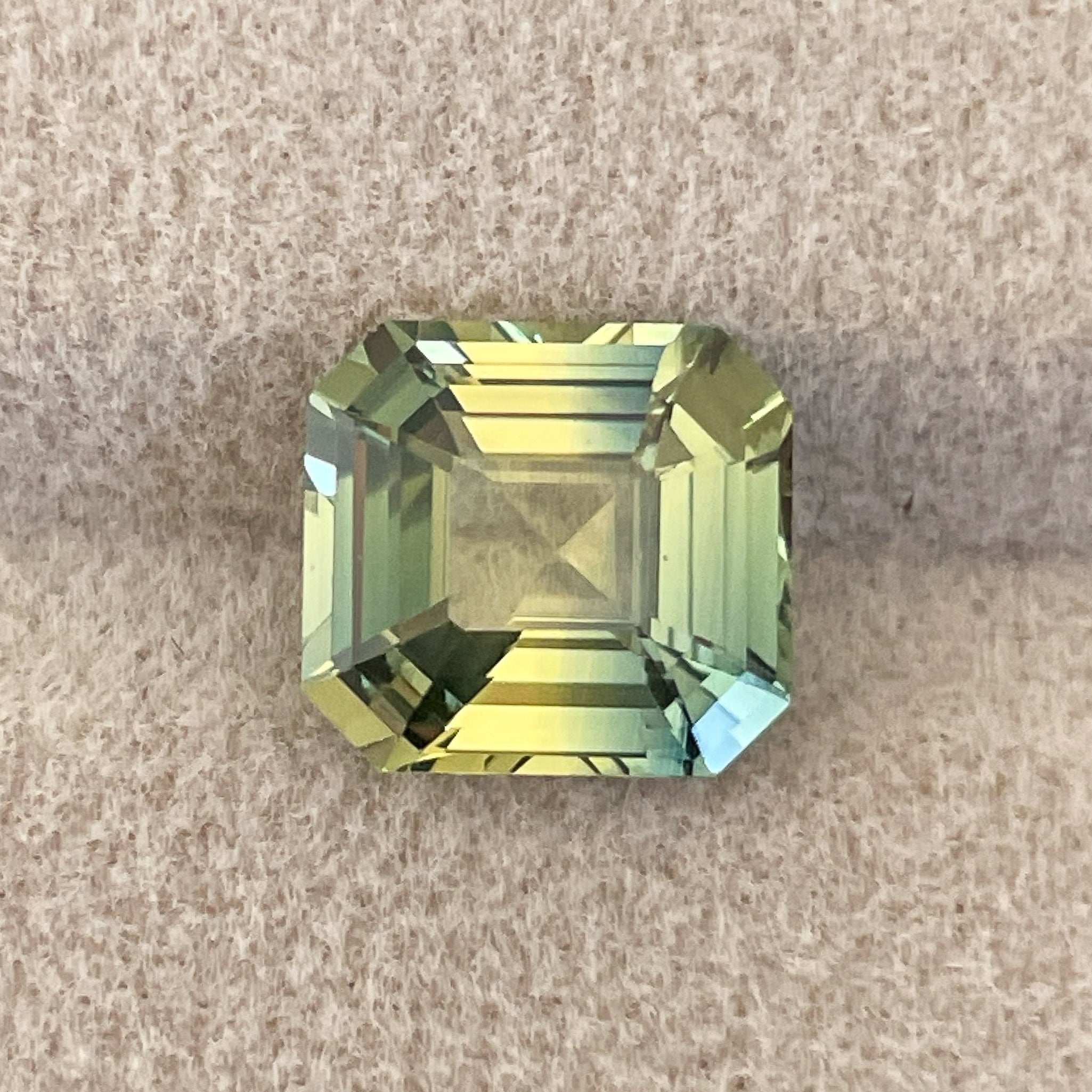 Teal bi-color Parti Sapphire 4.02 Ct Asscher emerald cut, loose gemstone from NASHGEMS, showcasing green and yellow hues.