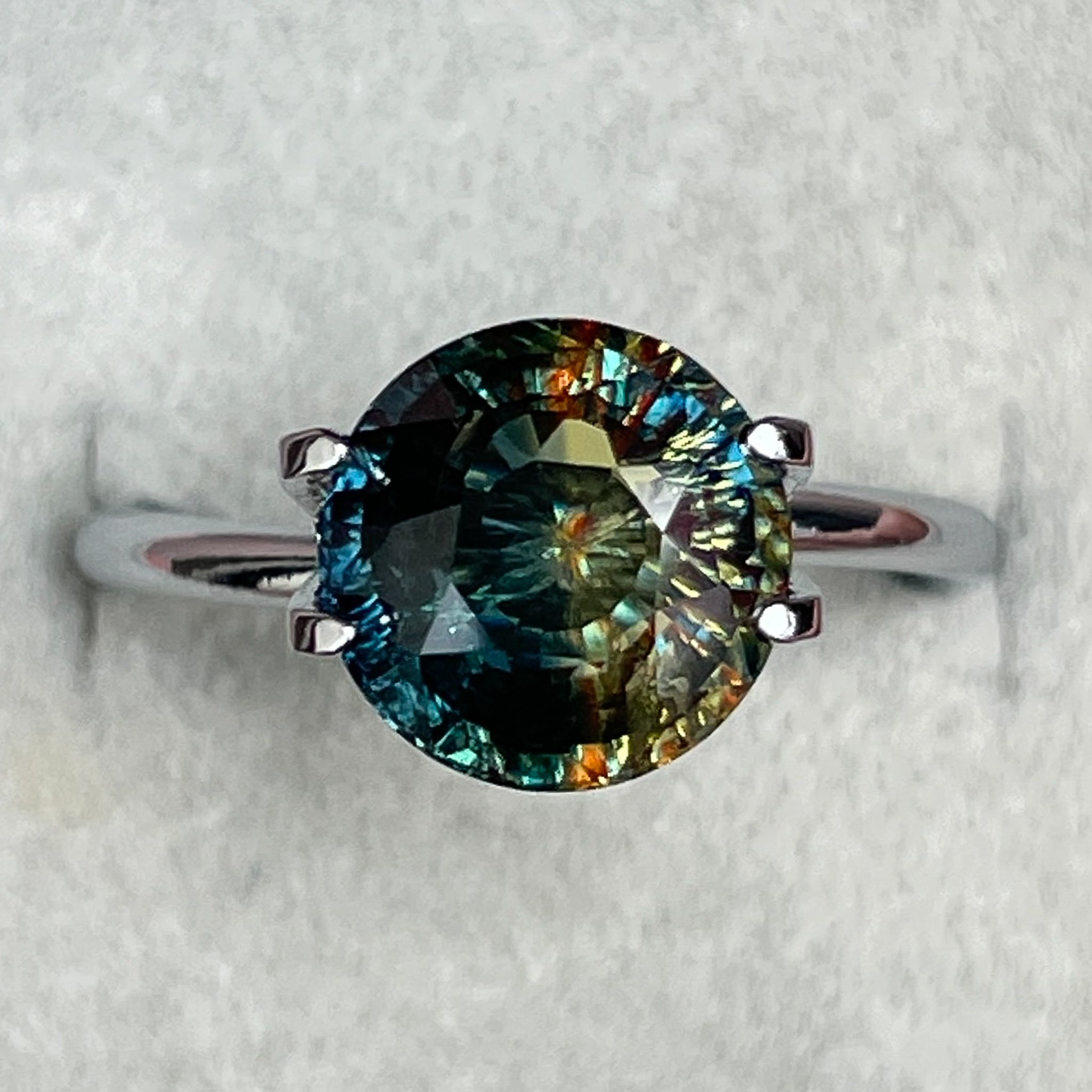 Teal bi-color sapphire, 3.70 Ct round cut loose gemstone by NASHGEMS, perfect for engagement rings or custom jewelry.