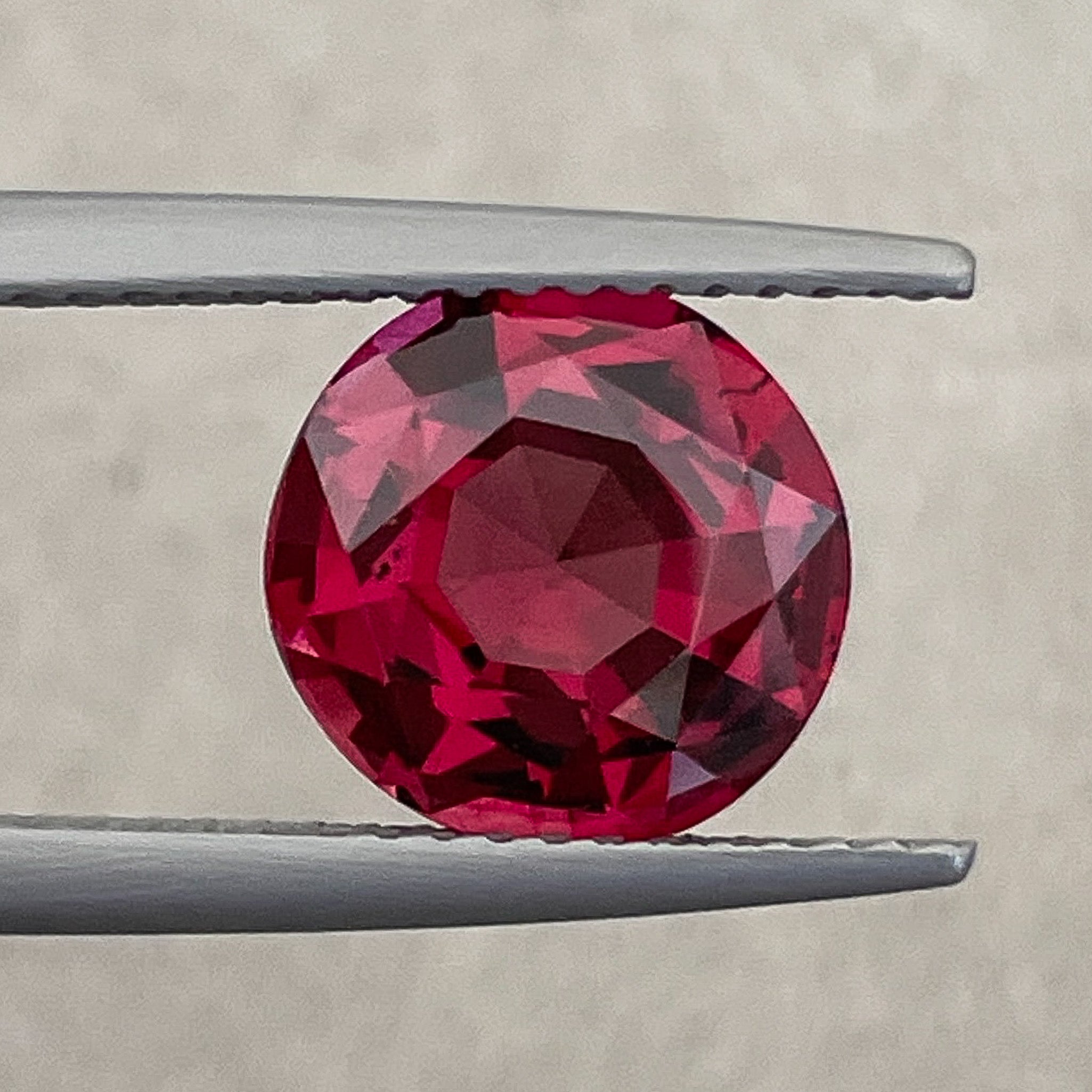 Natural Rhodolite Garnet 3.13 Ct round cut with vibrant raspberry red color, VVS clarity, suitable for engagement rings.