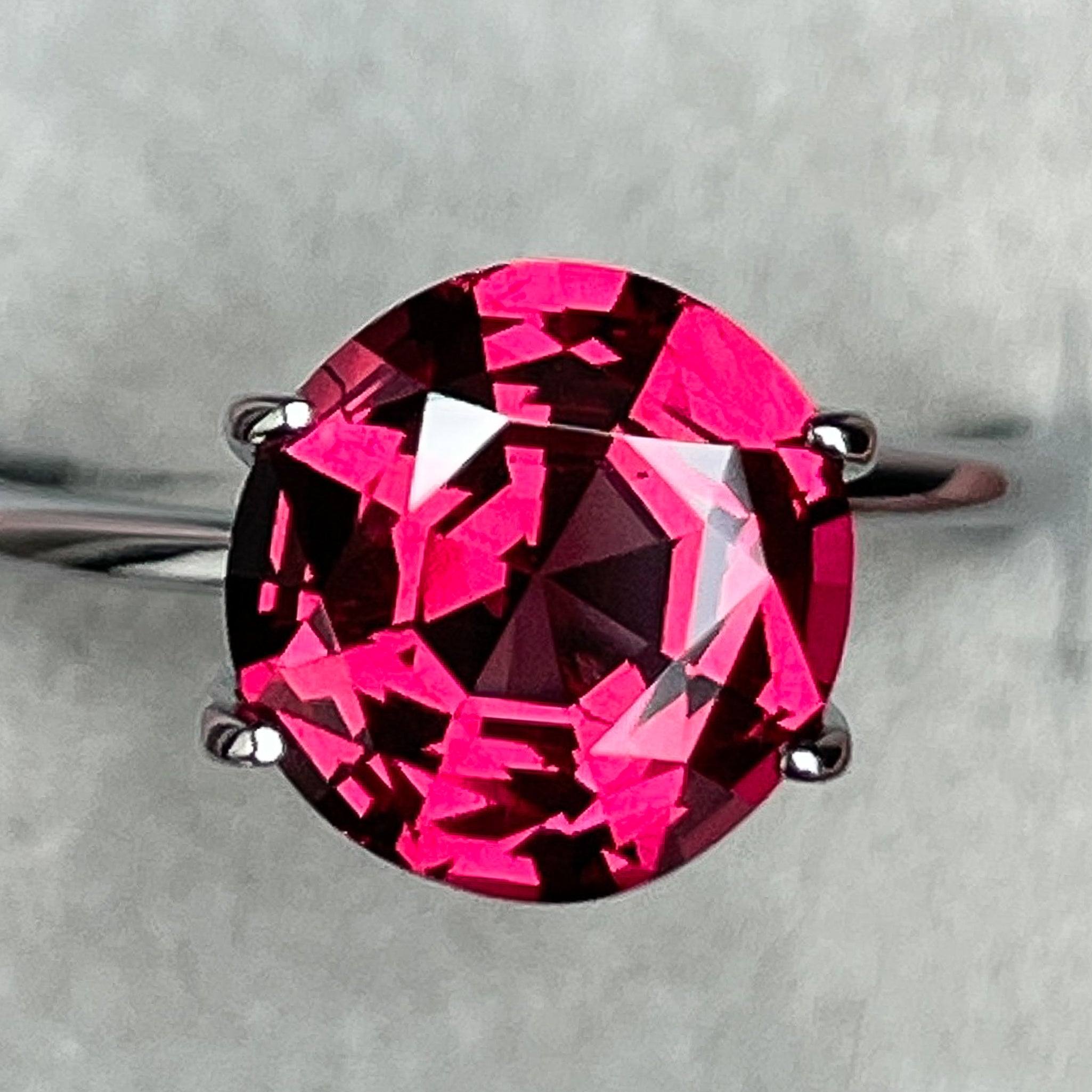 Natural Rhodolite Garnet 3.13 Ct round cut gemstone from NASHGEMS, showcasing deep raspberry red color and VVS clarity.