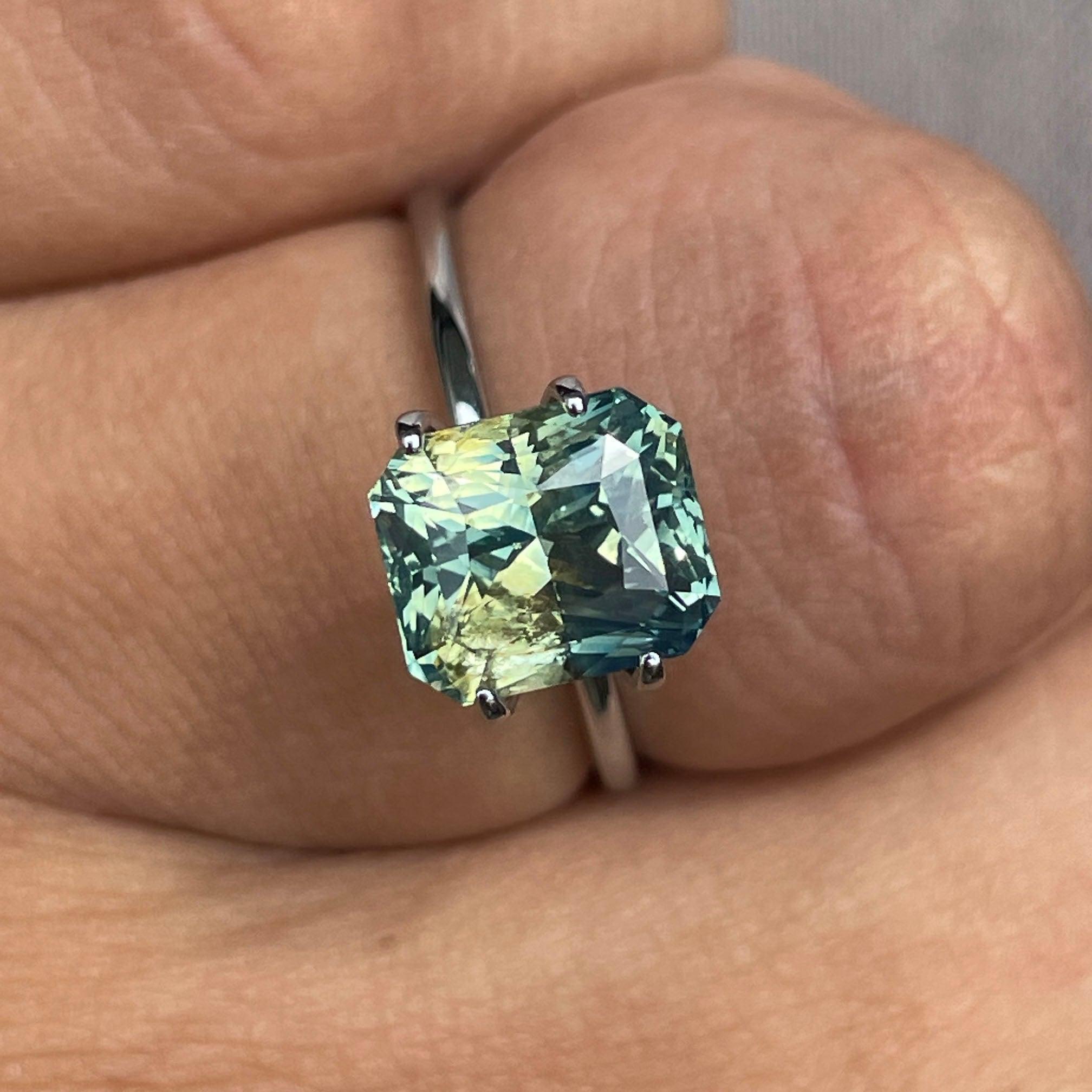 Teal sapphire loose gemstone, 4.55 carats, radiant cut, vibrant green and blue hues, perfect for jewelry making by NASHGEMS.