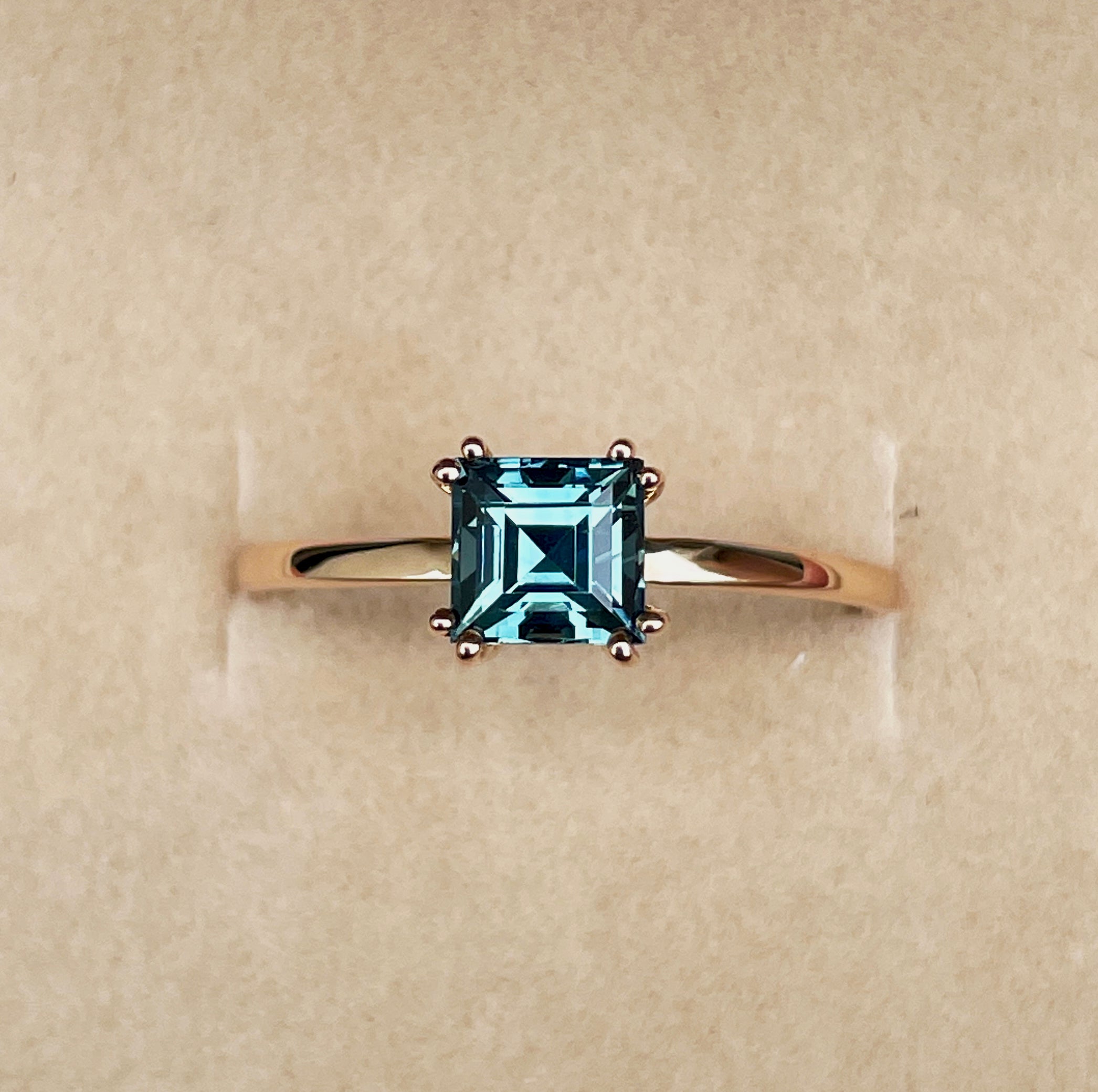 elegant ring features a 1.00 crt Natural Teal Sapphire surrounded by sparkling natural white sapphire set in a solid 18k Rose Gold ring setting. - NASHGEMS