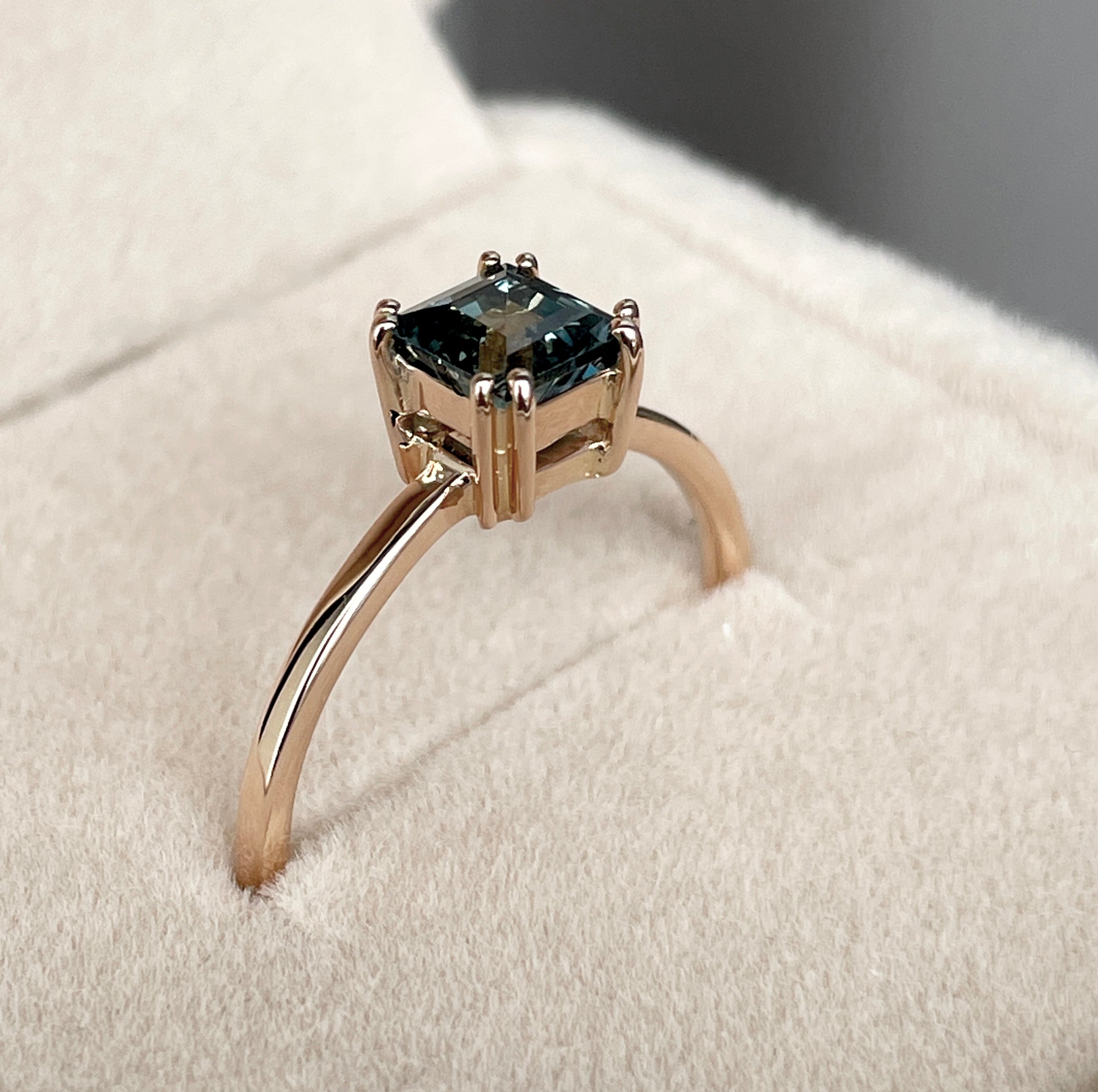 elegant ring features a 1.00 crt Natural Teal Sapphire surrounded by sparkling natural white sapphire set in a solid 18k Rose Gold ring setting. - NASHGEMS