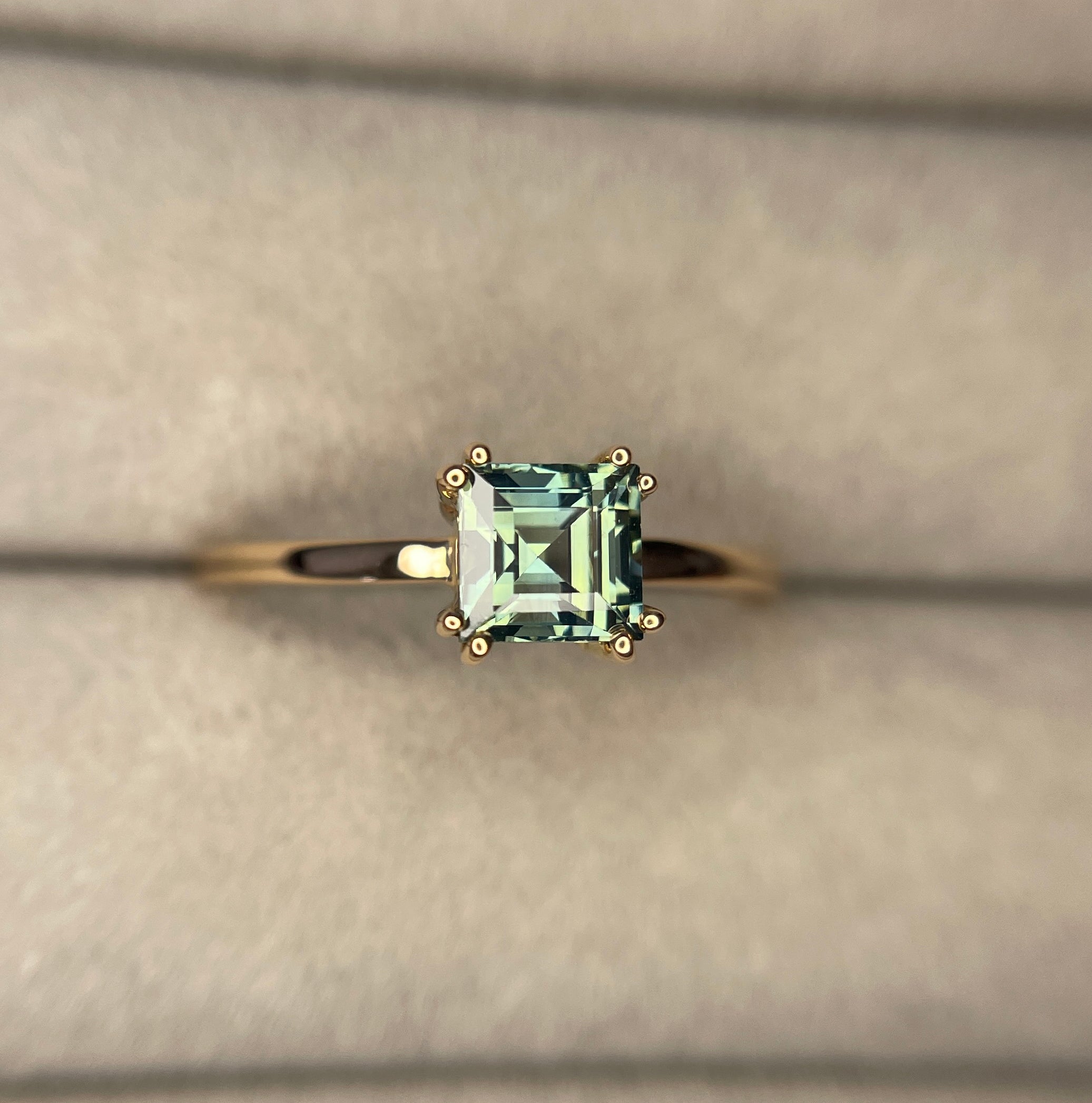 elegant ring features a 1.00 crt Natural Teal Sapphire surrounded by sparkling natural white sapphire set in a solid 18k Rose Gold ring setting. - NASHGEMS