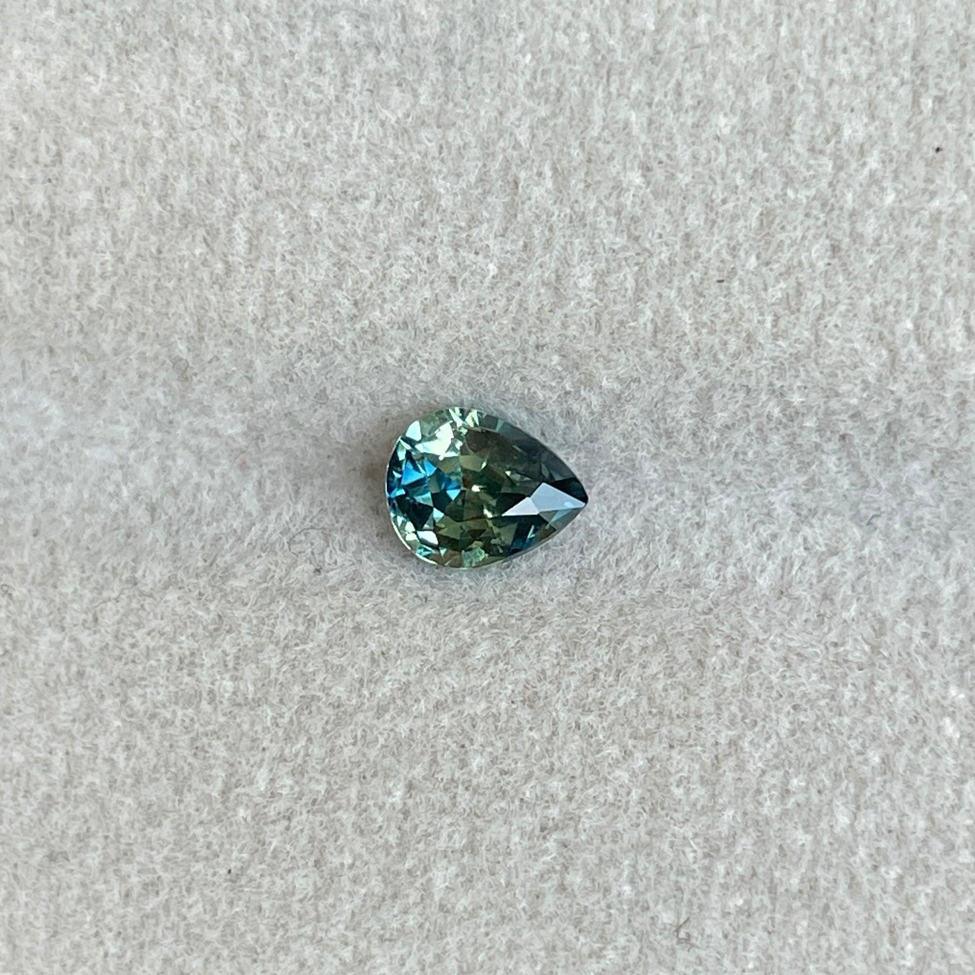 Teal sapphire loose gemstone, 0.83 carats, bi-colored parti sapphire in green and blue, perfect for September birthstone jewelry.