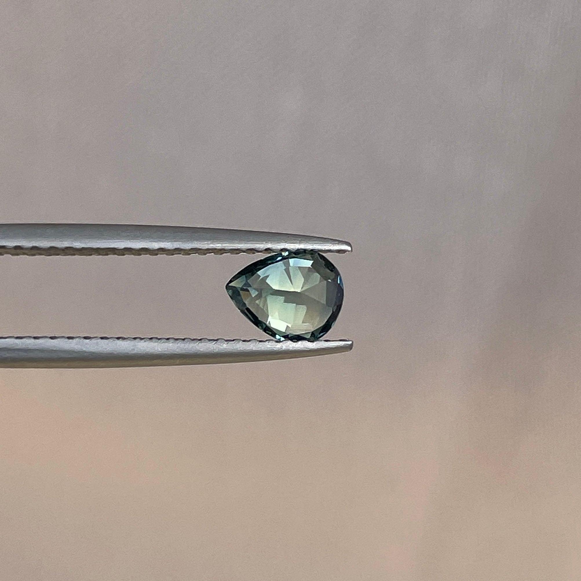 Bi-colored teal and green sapphire gemstone, 0.83 carats, loose parti sapphire from NASHGEMS, perfect for September birthstone jewelry.