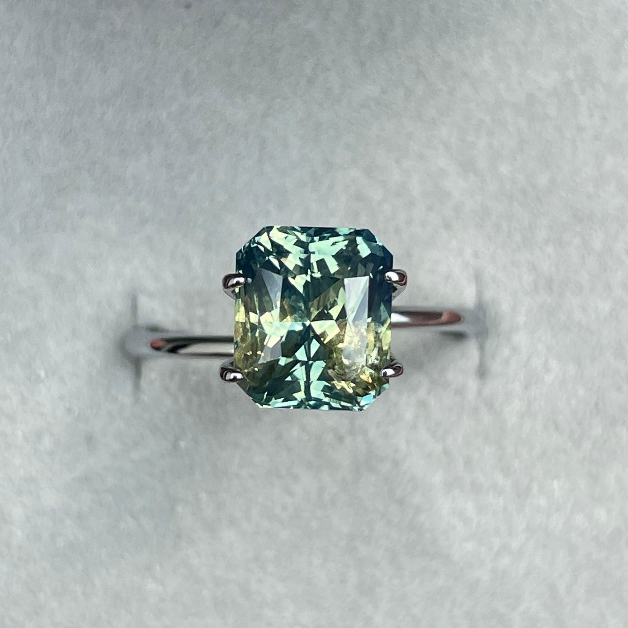 Bi-colored teal sapphire gemstone, 4.55 carats, radiant cut, loose Parti sapphire from NASHGEMS for jewelry making.