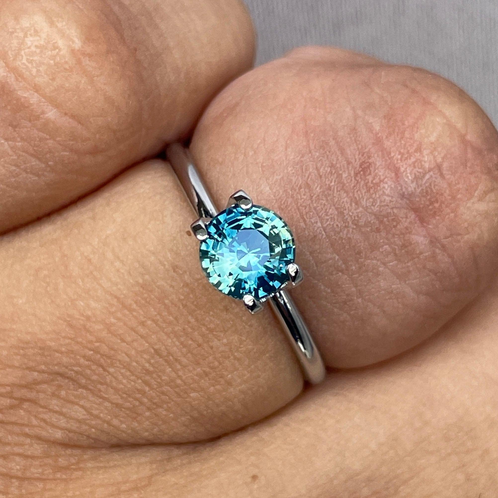 Teal bi-colored parti sapphire gemstone, 1.31 carats, round shape, loose September birthstone, from NASHGEMS.