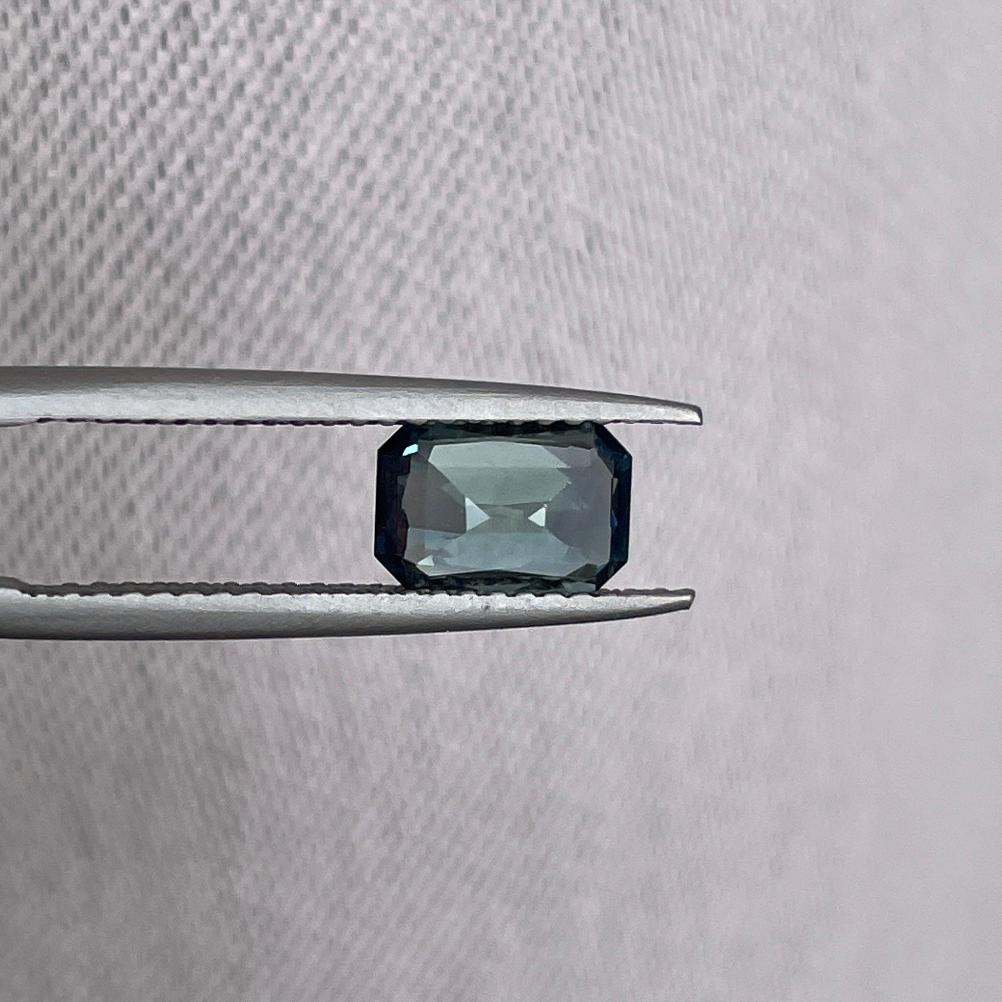 Teal bi-colored parti sapphire loose gemstone, 1.54 carats, emerald cut, vibrant green and blue hues, perfect for September birthstone jewelry.
