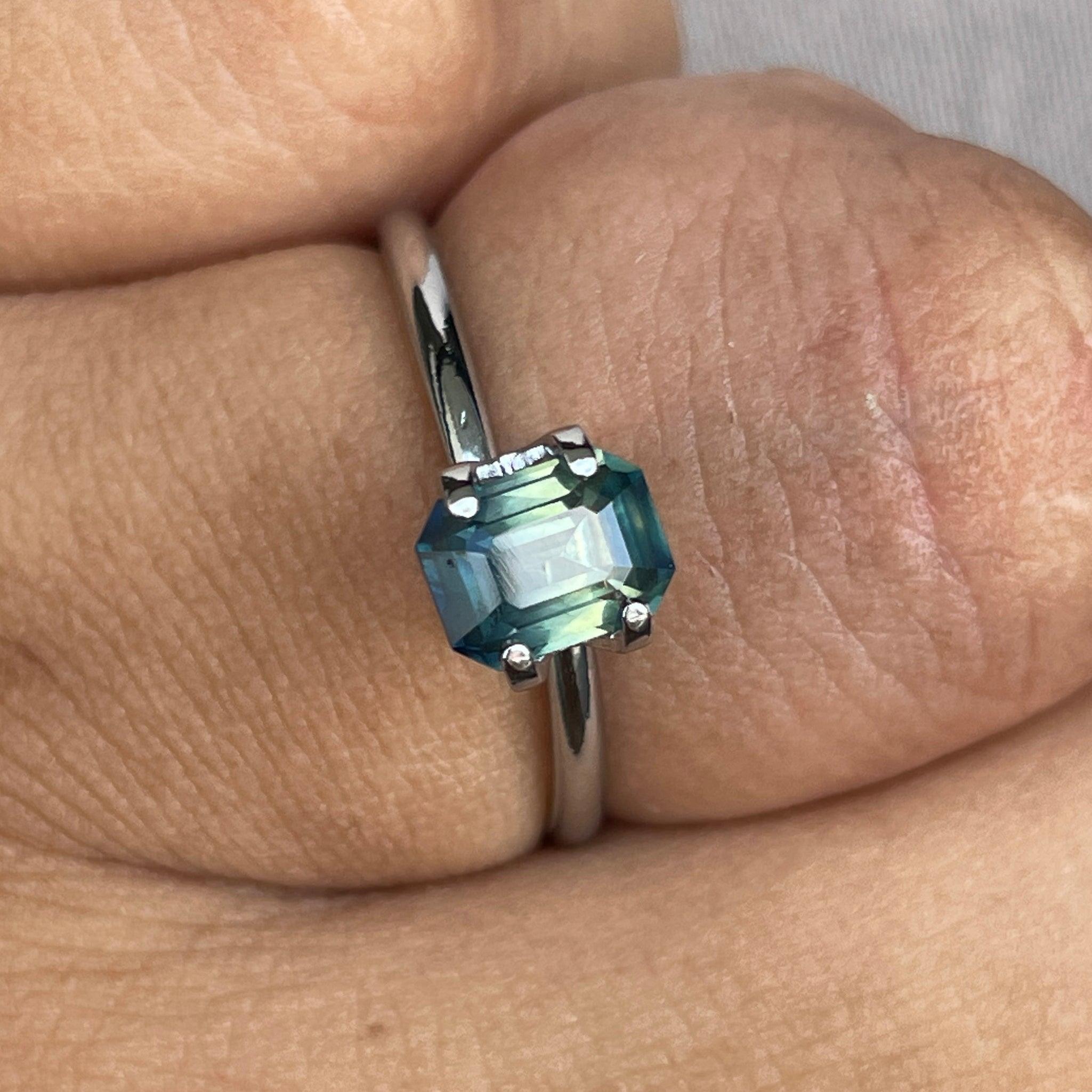 Loose teal sapphire gemstone with bi-colored parti sapphires, 1.09 carats, showcasing vibrant green and blue hues, perfect for September birthstone.