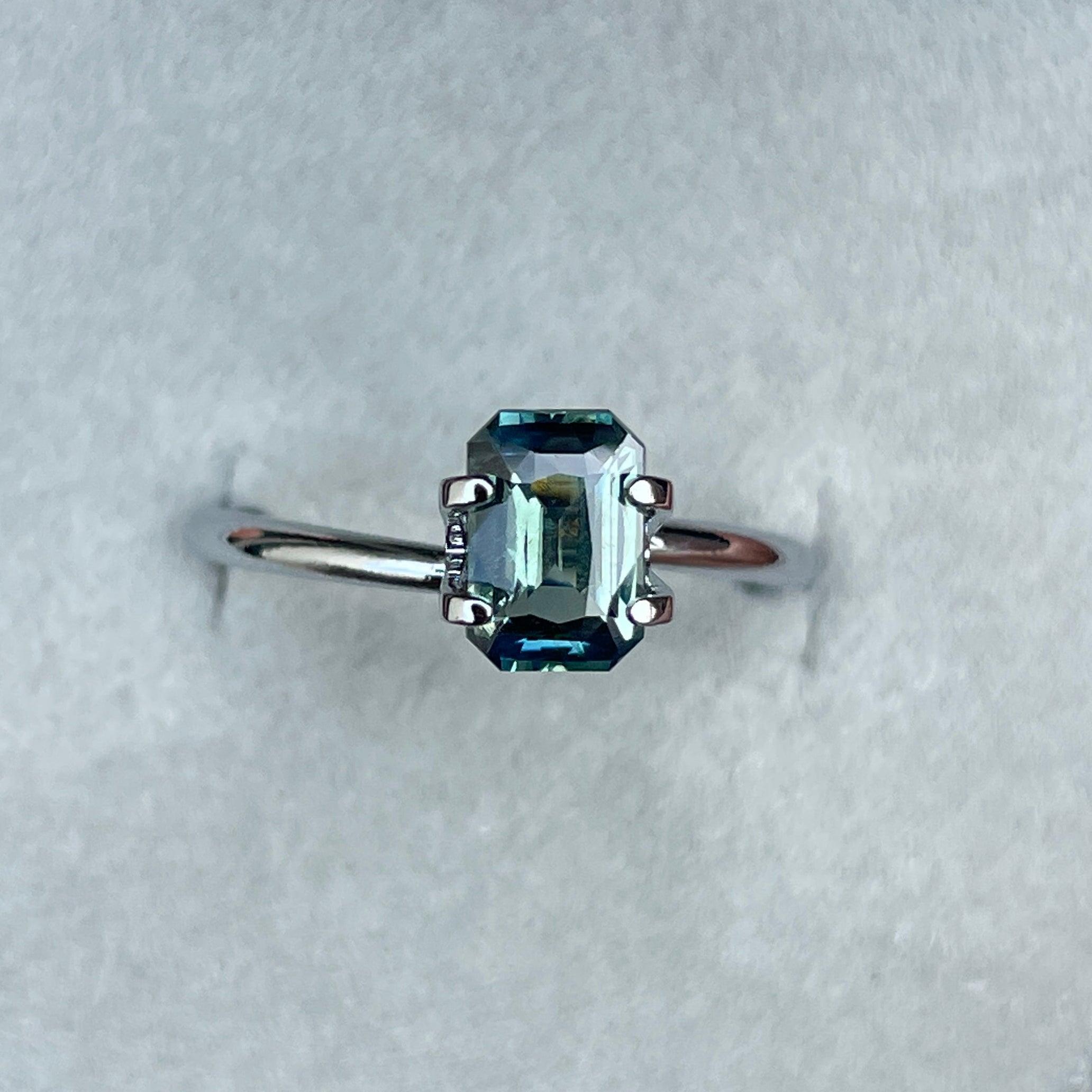Teal NASHGEMS bi-coloured parti sapphire loose stone, emerald cut, 1.54 carats, vibrant green and blue for September birthstone.