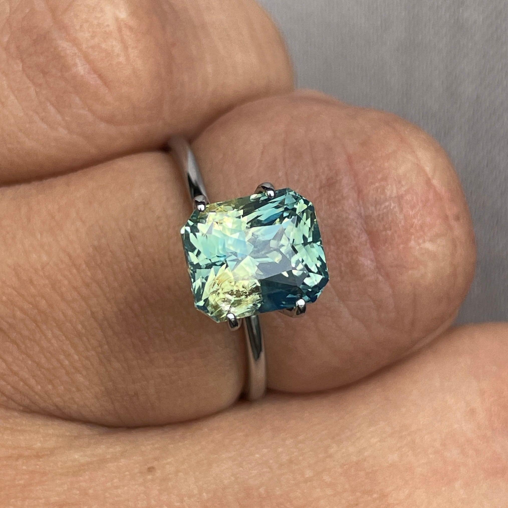 Teal sapphire gemstone by NASHGEMS, 4.55 carats, radiant cut, bi-colored parti sapphire in green and blue for jewelry making.