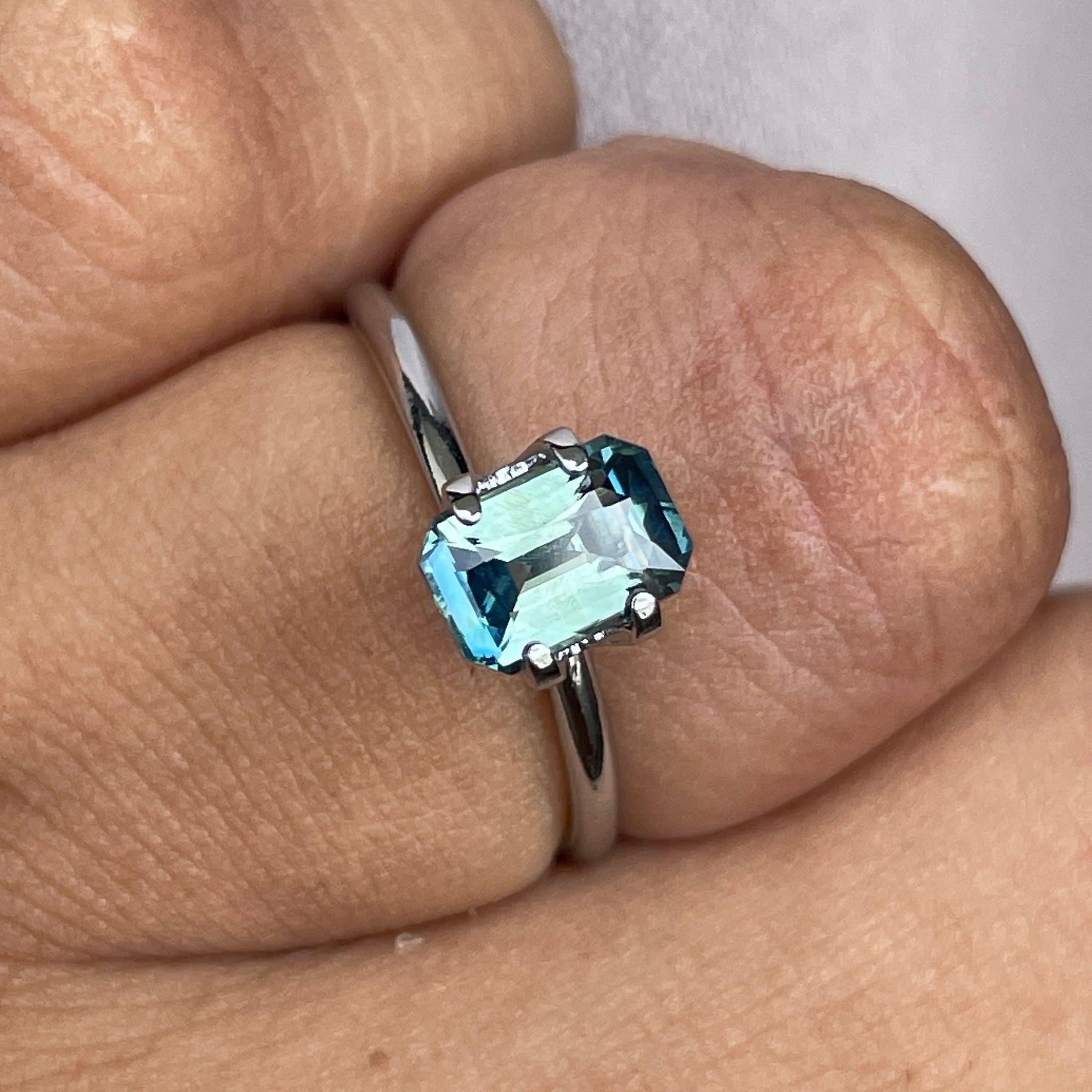 Teal-colored bi-parti sapphire gemstone, emerald cut, 1.54 carats, loose precious stone from NASHGEMS, ideal for September birthstone.