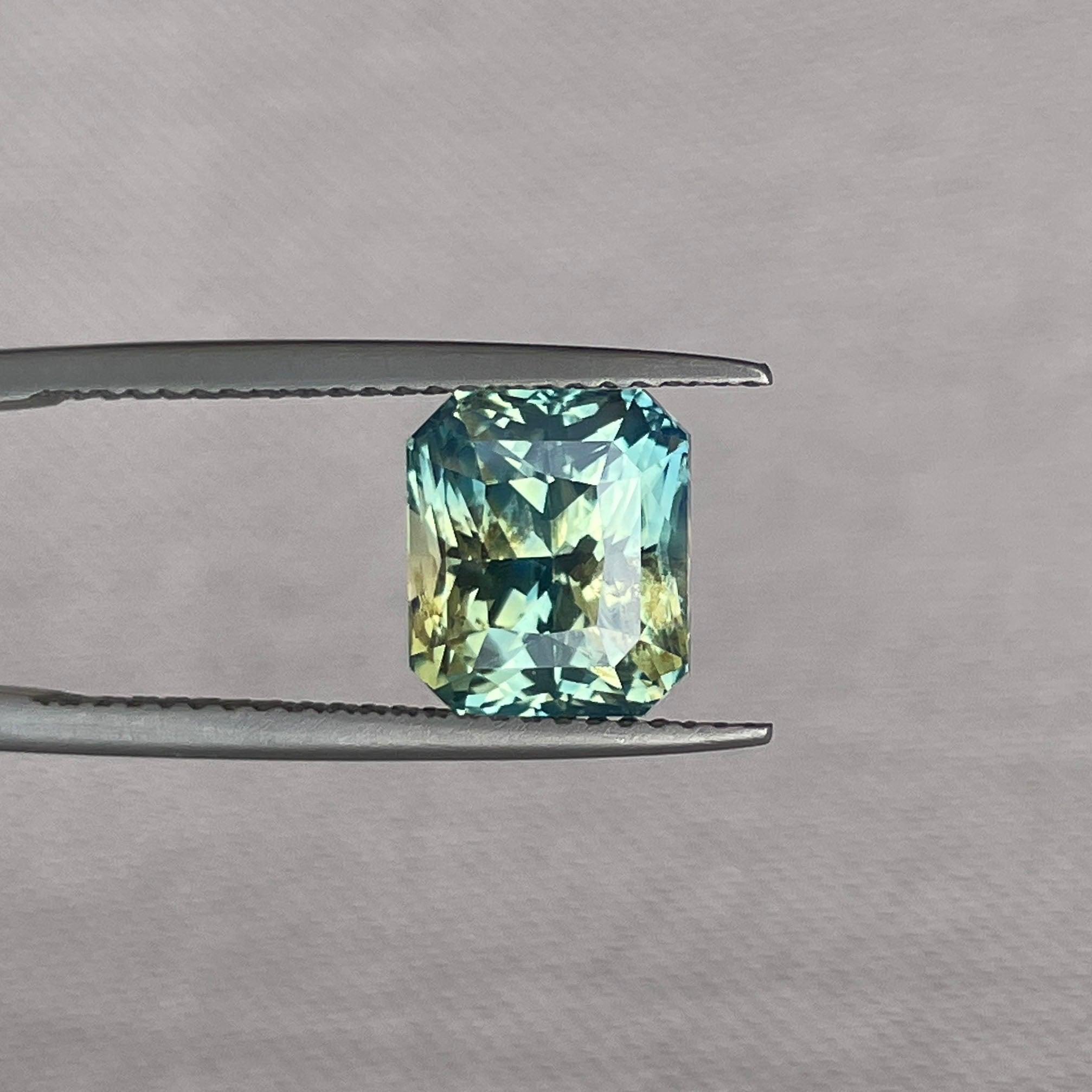 Bi-colored teal sapphire gemstone, 4.55 ct. radiant cut loose parti sapphire for jewelry, vibrant green and blue hues, September birthstone.