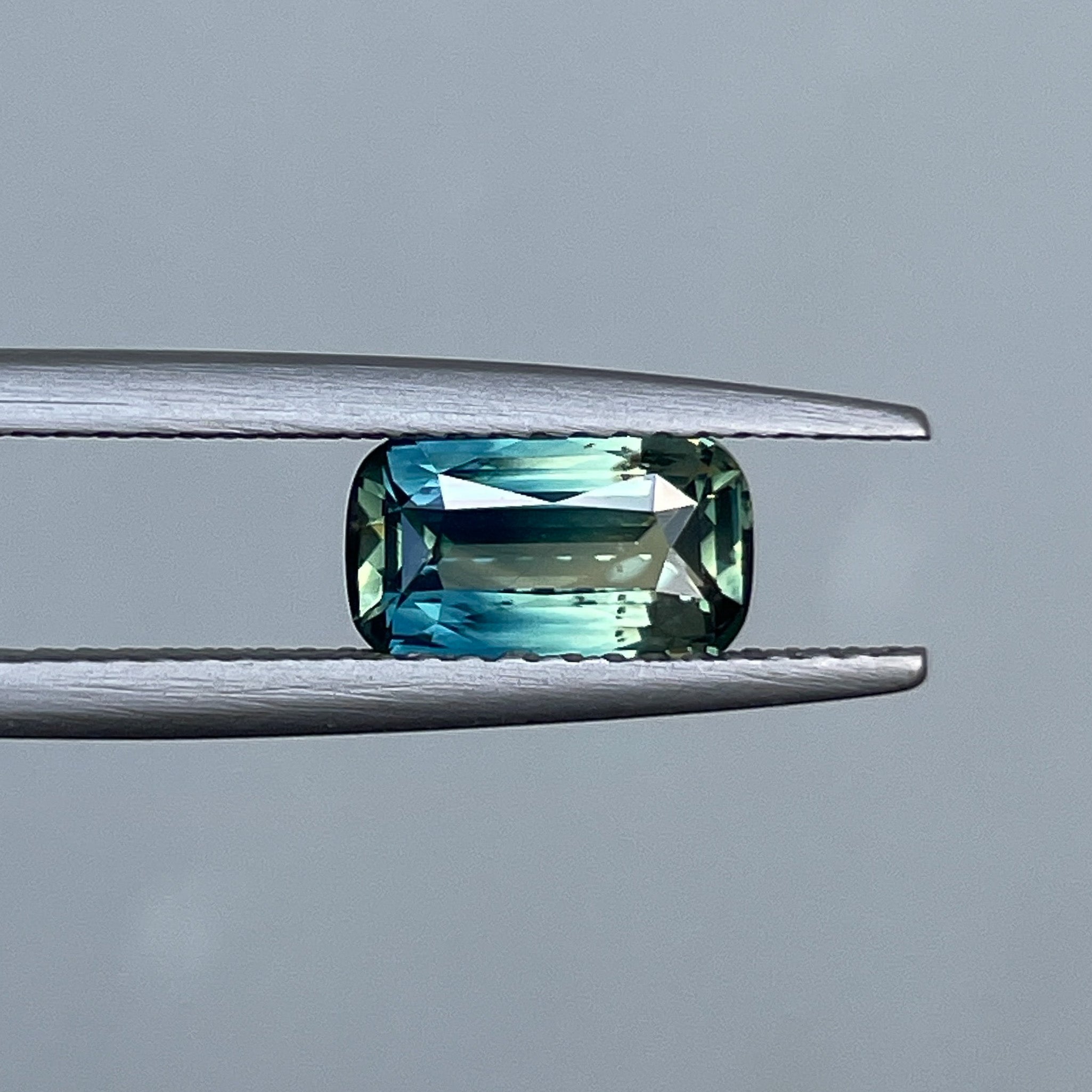 Natural teal parti bi-color sapphire, 1.55 Ct elongated cushion cut, loose gemstone by NASHGEMS for jewelry or engagement rings.