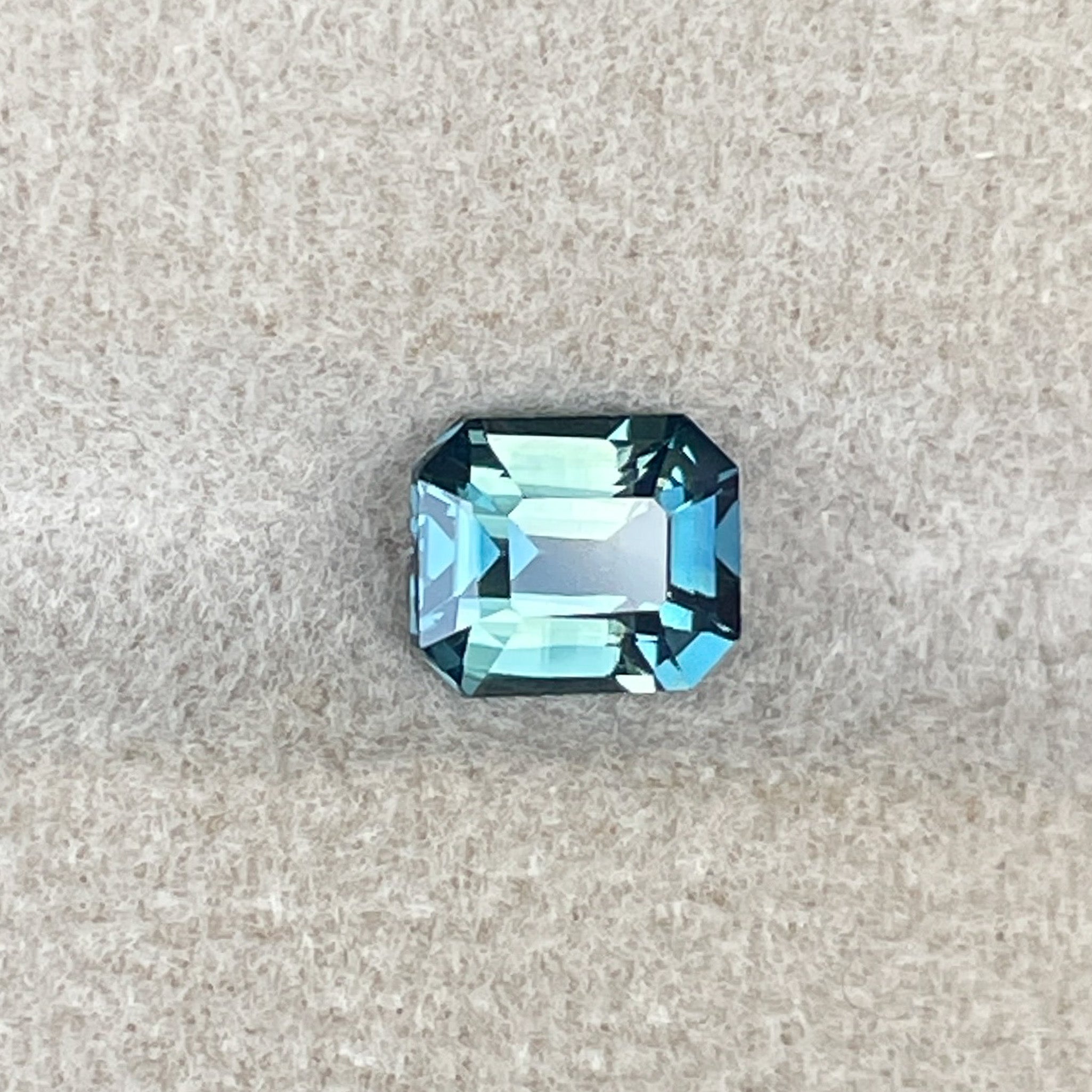 Natural teal and green bi-color sapphire, 1.38 ct emerald cut, loose no heat sapphire from NASHGEMS for engagement rings.