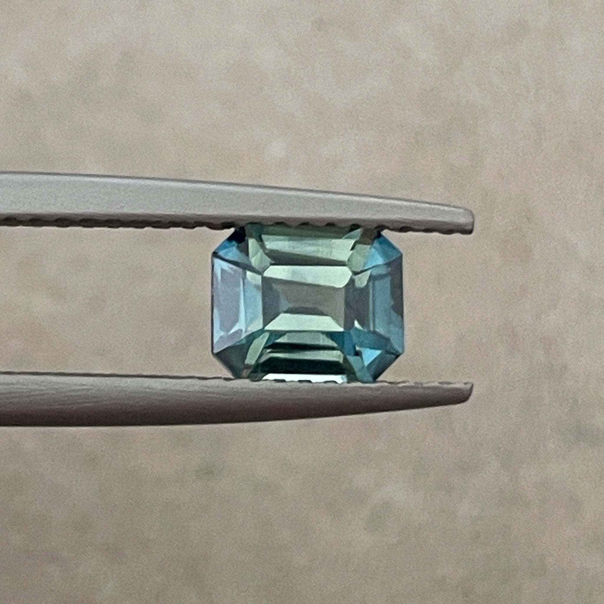 Natural teal blue-green bi-color sapphire 1.38 Ct emerald cut, loose no heat sapphire from NASHGEMS for engagement jewelry.
