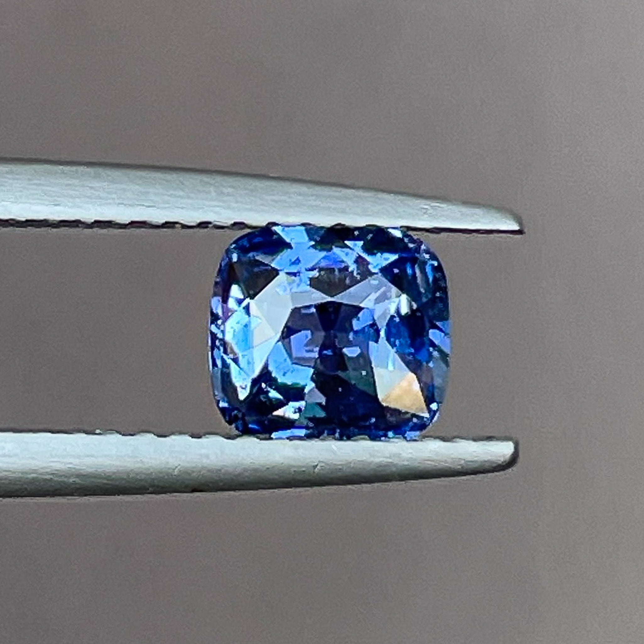 Natural Ceylon Blue Sapphire 1.06 Ct cushion cut loose gemstone by NASHGEMS, showcasing vibrant blue color and cushion shape.