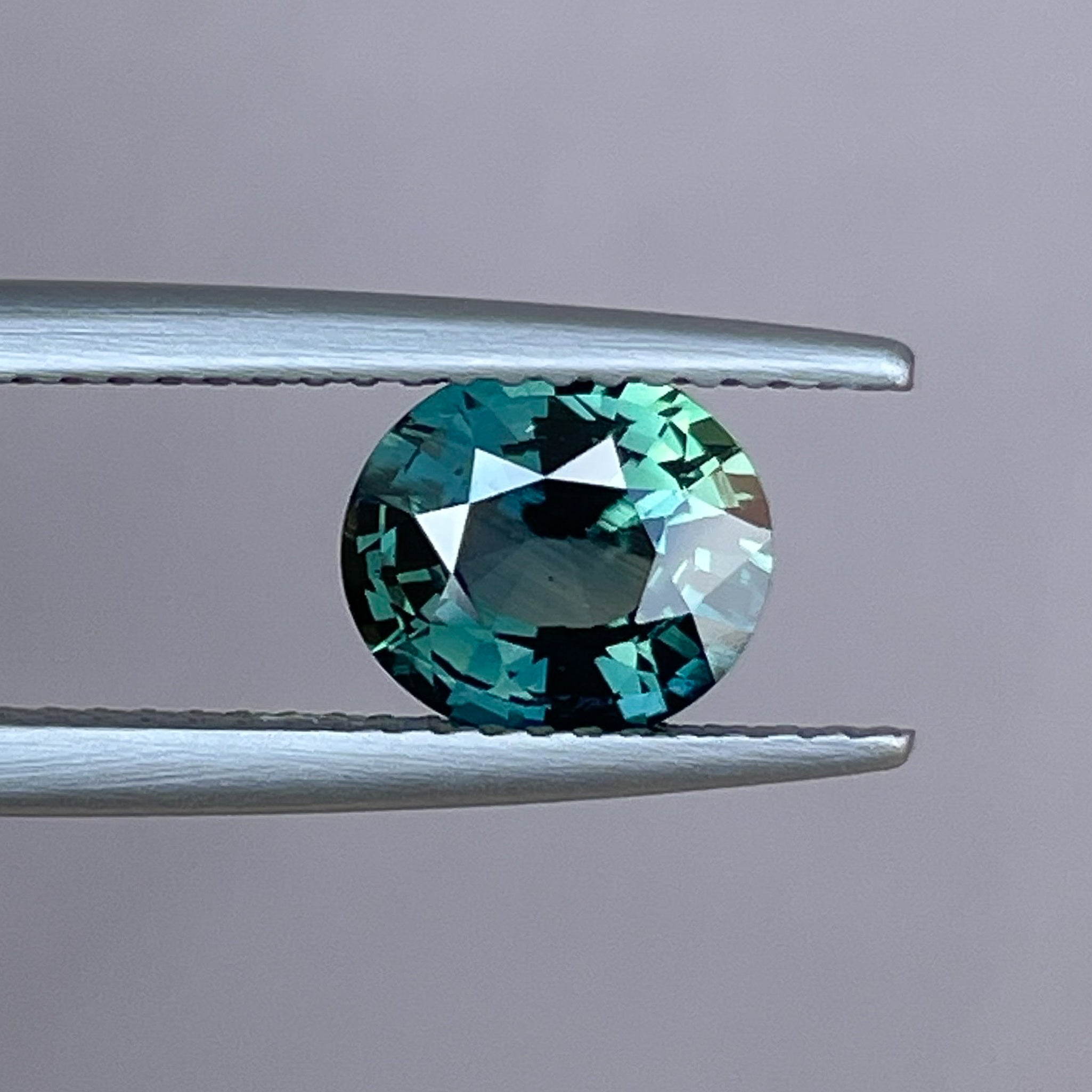 Natural forest green sapphire, 1.56 Ct oval cut loose teal gemstone from NASHGEMS for engagement or custom jewelry.