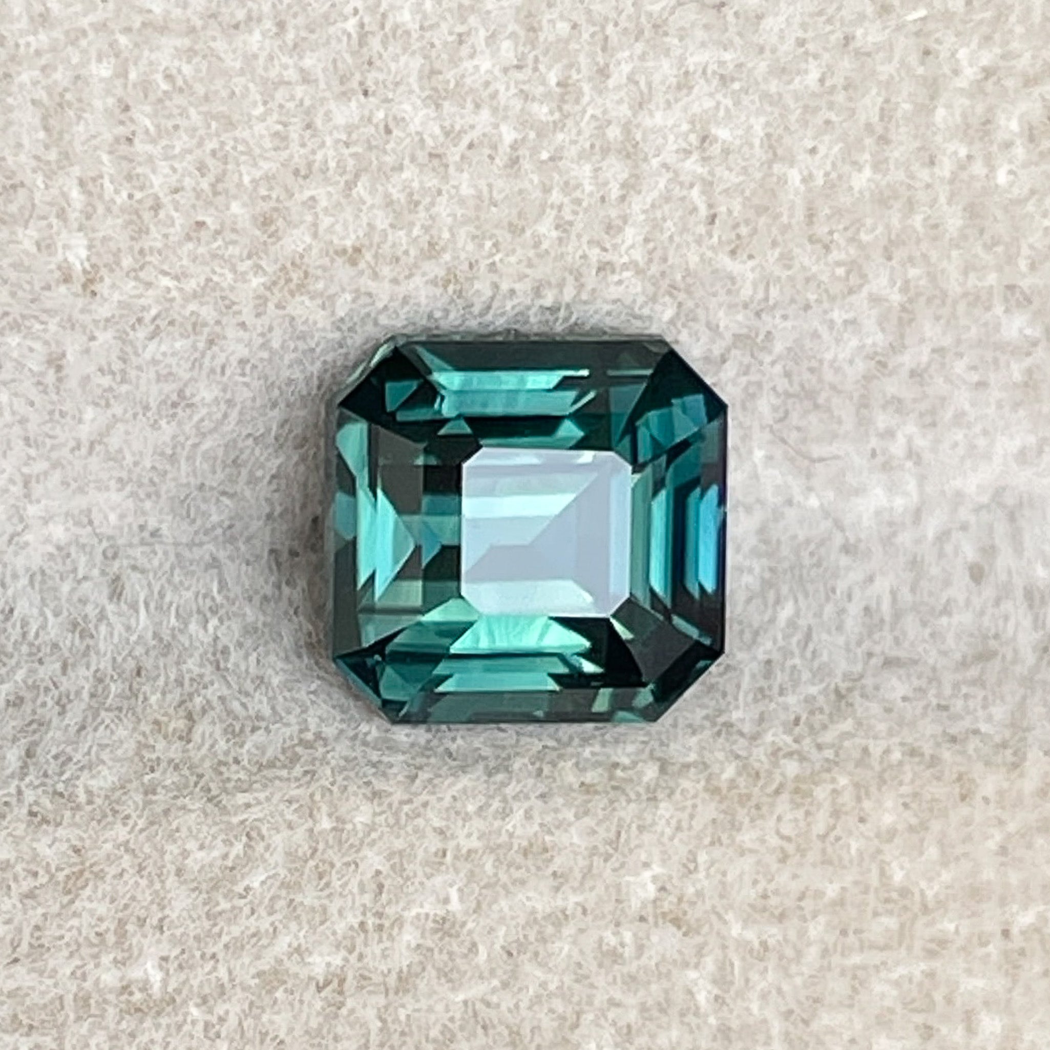 Teal green sapphire loose gemstone, 2.02 Ct emerald cut, heat treated, from NASHGEMS for custom engagement rings.