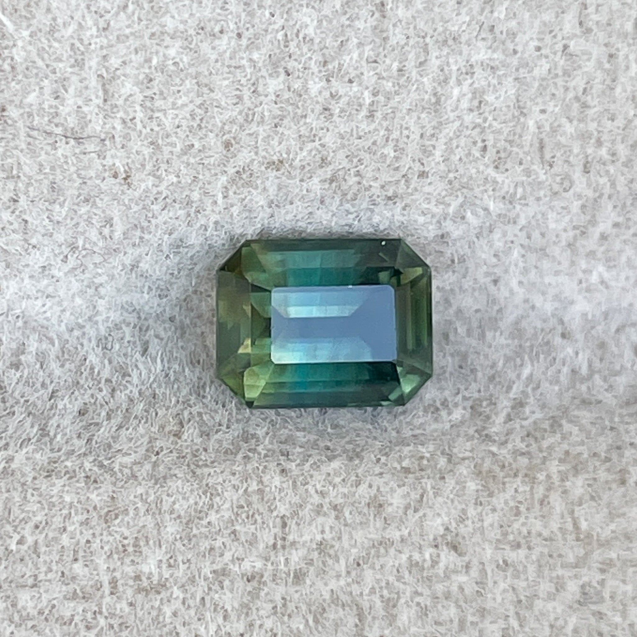 Teal natural bi-color sapphire 1.13 Ct emerald cut loose gemstone by NASHGEMS, ideal for engagement rings or custom jewelry.