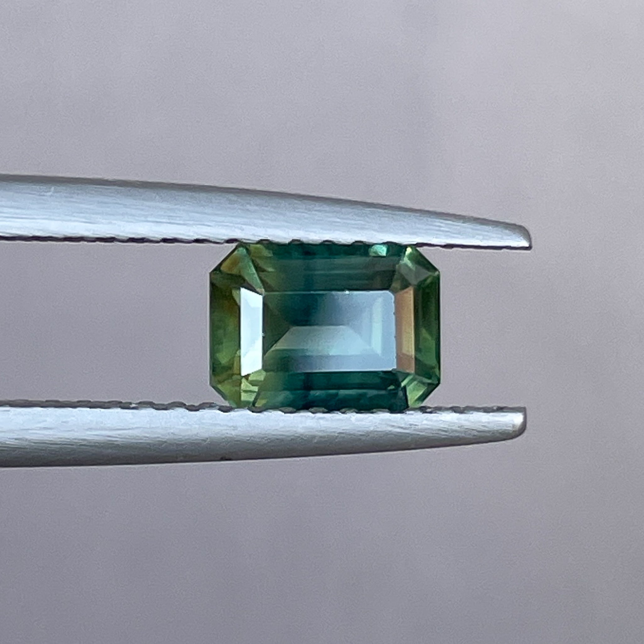 Teal natural bi-color sapphire 1.13 Ct emerald cut loose gemstone from NASHGEMS, ideal for engagement rings or custom jewelry.