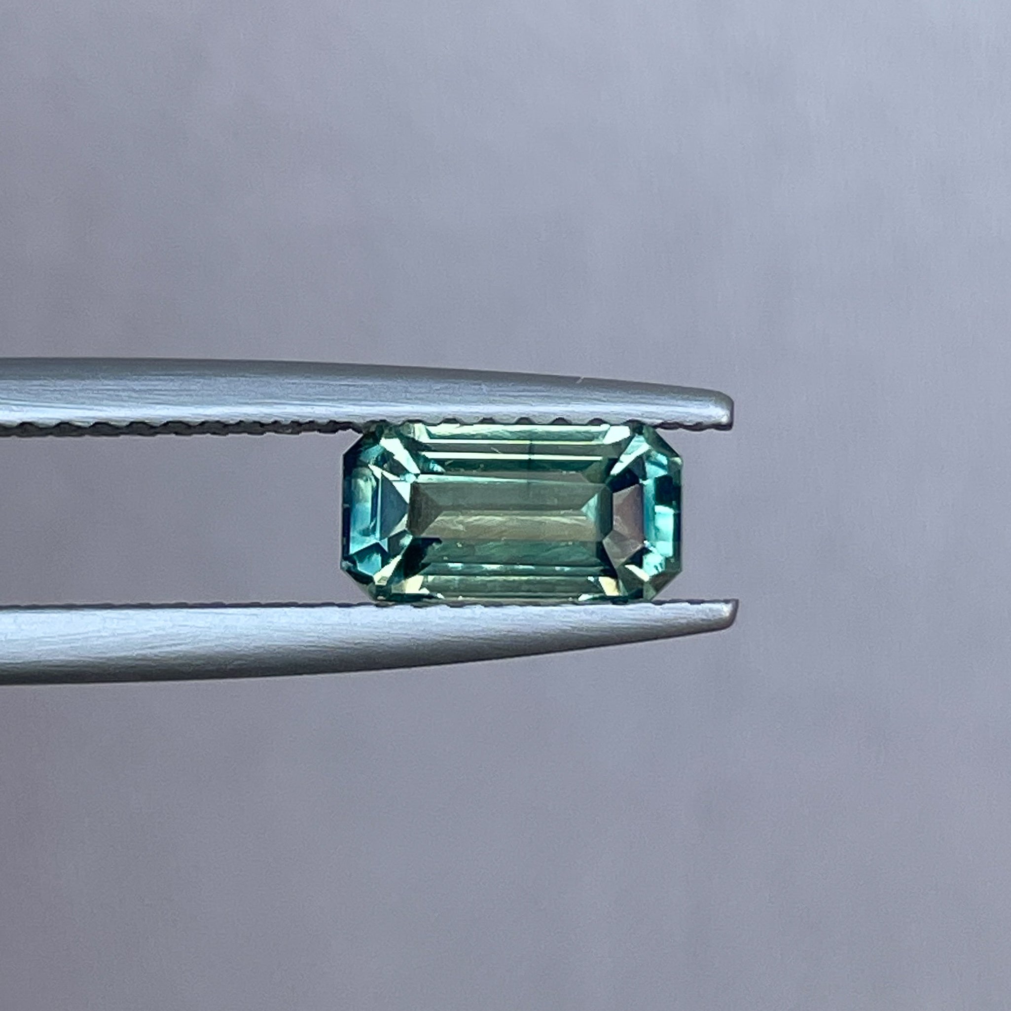 Teal sapphire loose gemstone, emerald cut, 1.49 carats, NASHGEMS, vibrant green and blue parti sapphire for September birthstone.