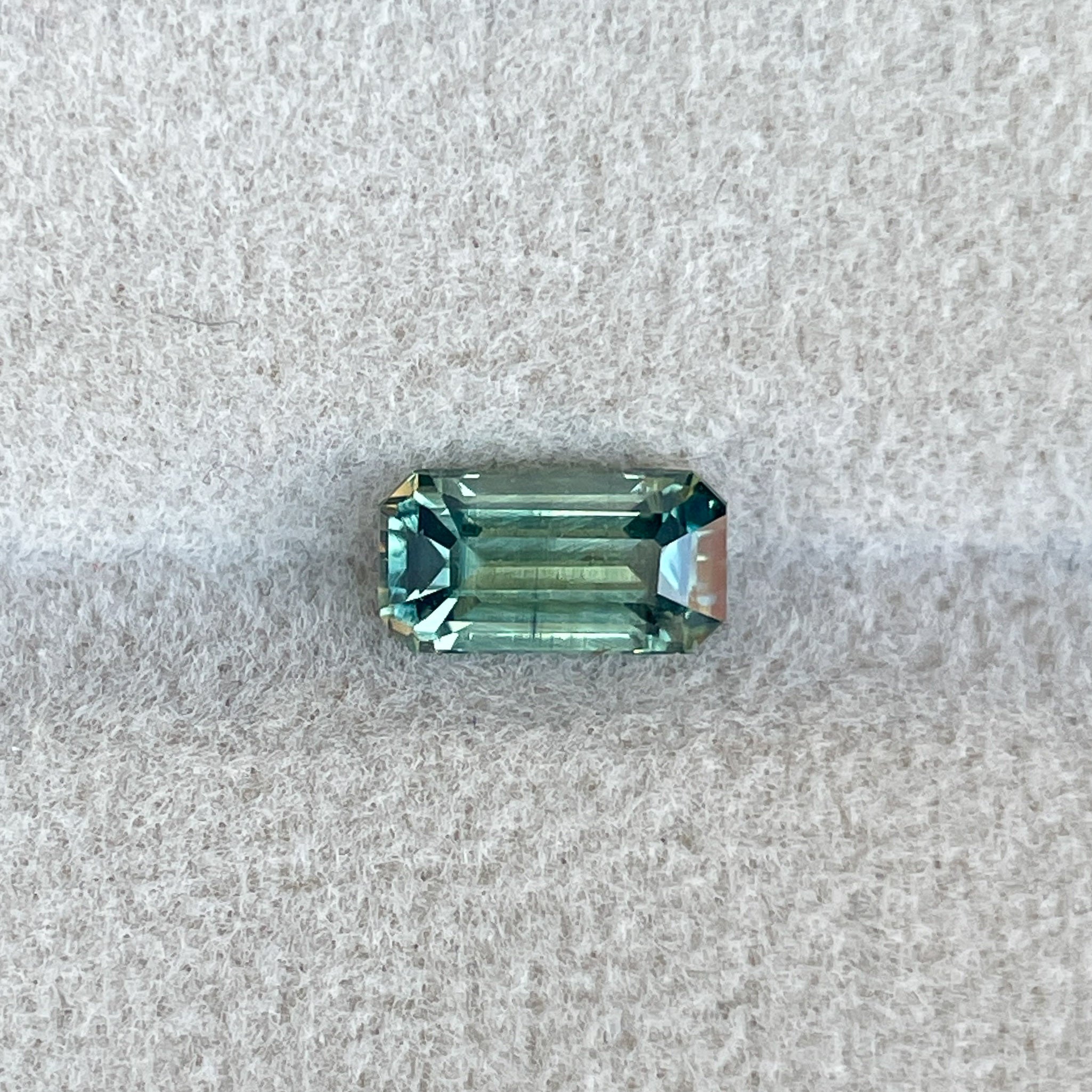 Teal sapphire loose gemstone, emerald cut, 1.49 carats, NASHGEMS, vibrant green and blue parti sapphire for September birthstone.