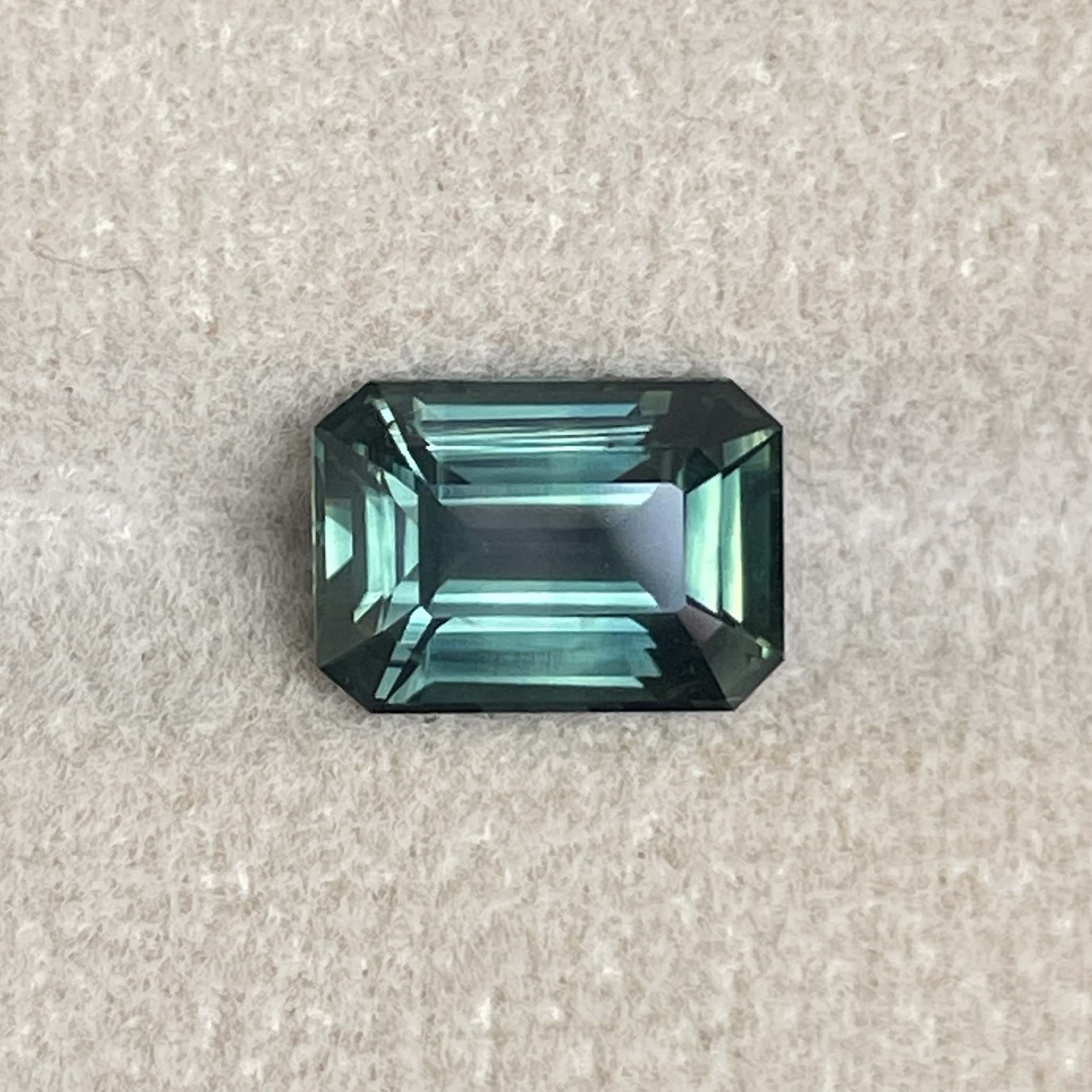 Natural green sapphire 3.03 Ct emerald cut loose gemstone from NASHGEMS, vibrant teal color, ideal for engagement rings.