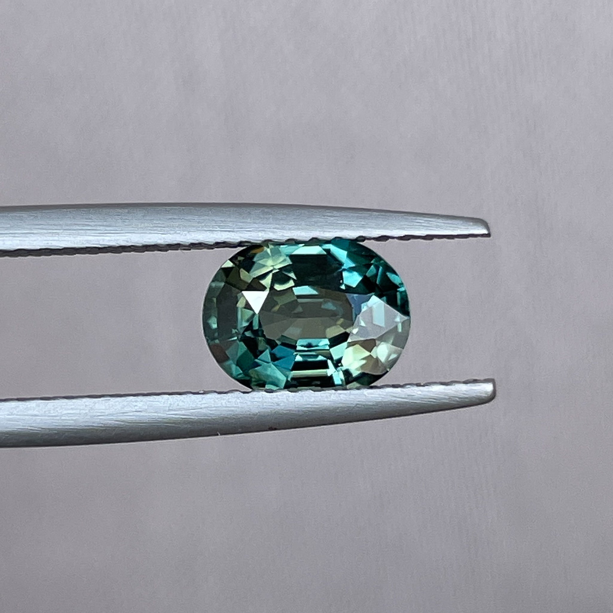Natural teal green sapphire, 1.52 ct oval cut loose gemstone by NASHGEMS, ideal for engagement rings or custom jewelry.
