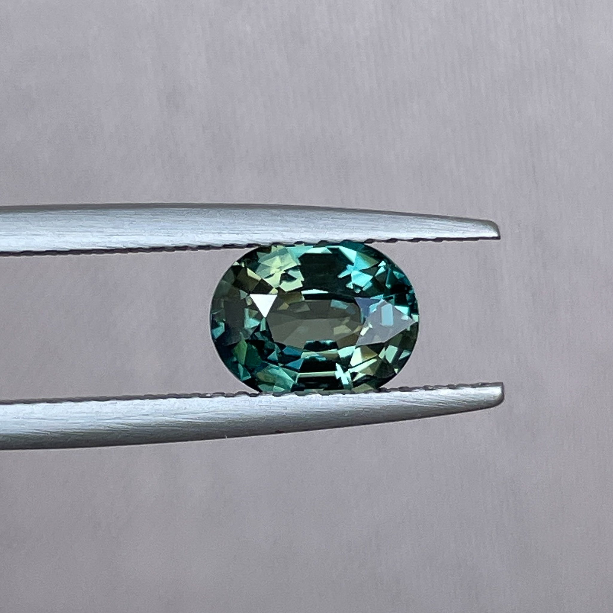 Natural teal green sapphire, 1.52 Ct oval cut, heat treated loose gemstone by NASHGEMS for engagement or custom jewelry.