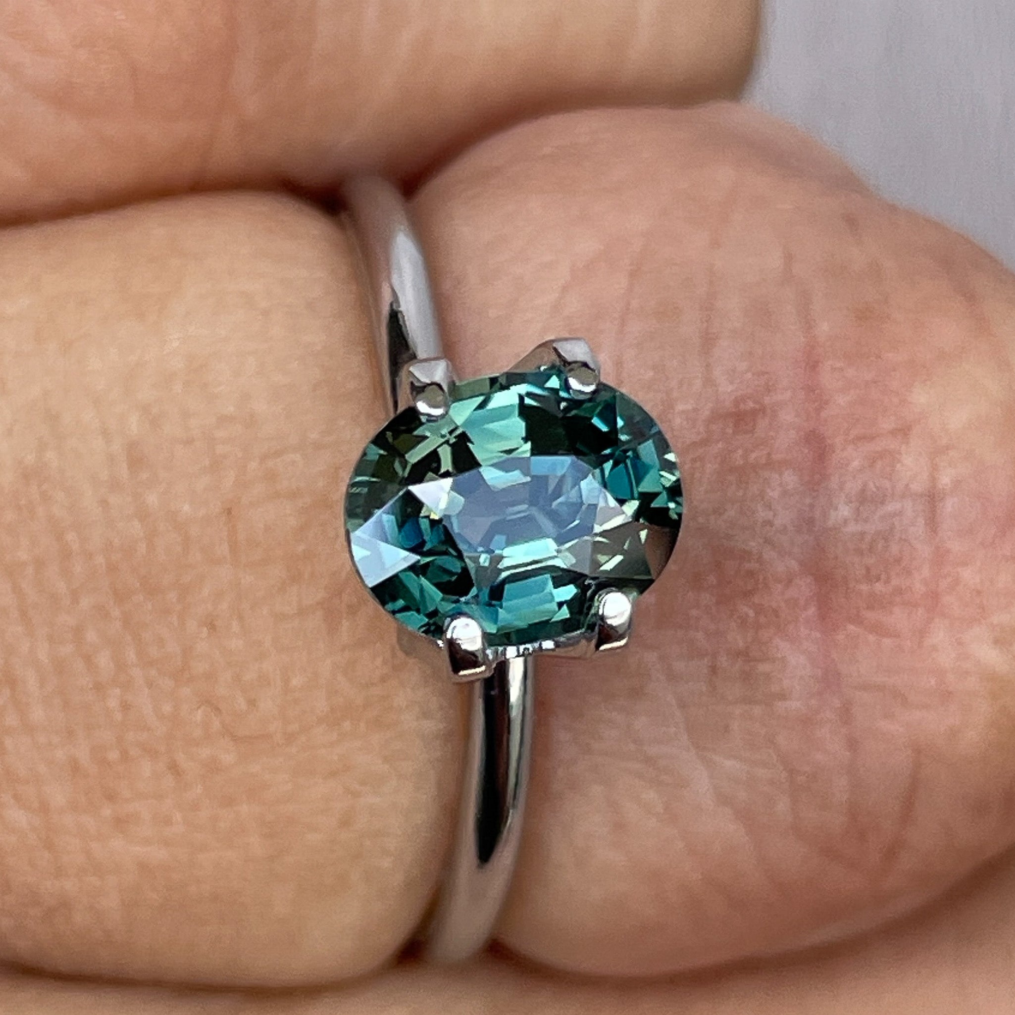 Teal green sapphire loose gemstone, 1.52 Ct oval cut, heat treated, from NASHGEMS, suitable for engagement or custom jewelry.