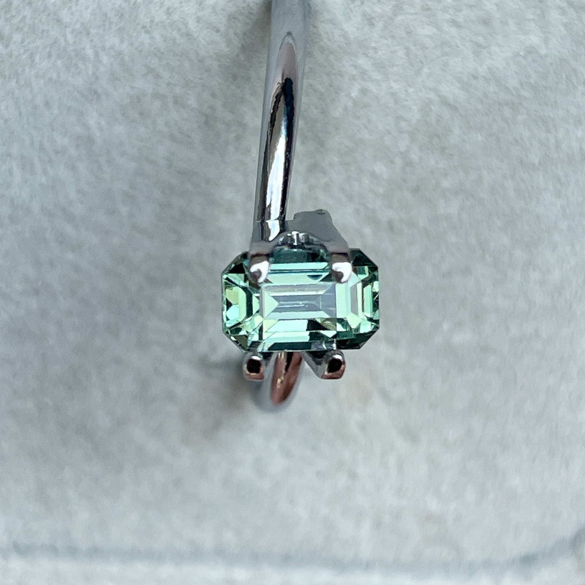 Natural pale green teal sapphire 1.24 Ct emerald cut by NASHGEMS, showcasing a vibrant, transparent loose gemstone for jewelry making.