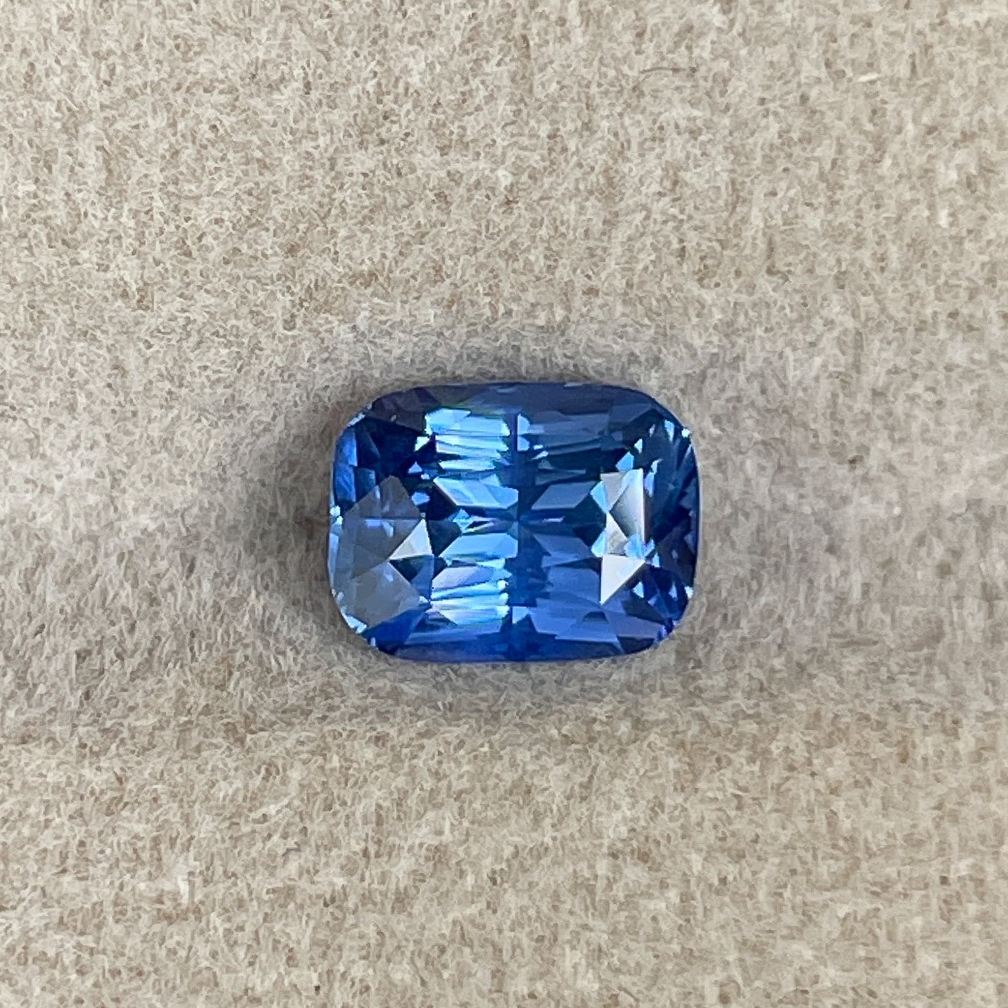 Natural Ceylon Blue Sapphire 1.60 Ct cushion cut, vivid blue loose gemstone by NASHGEMS, ideal for engagement or custom jewelry.