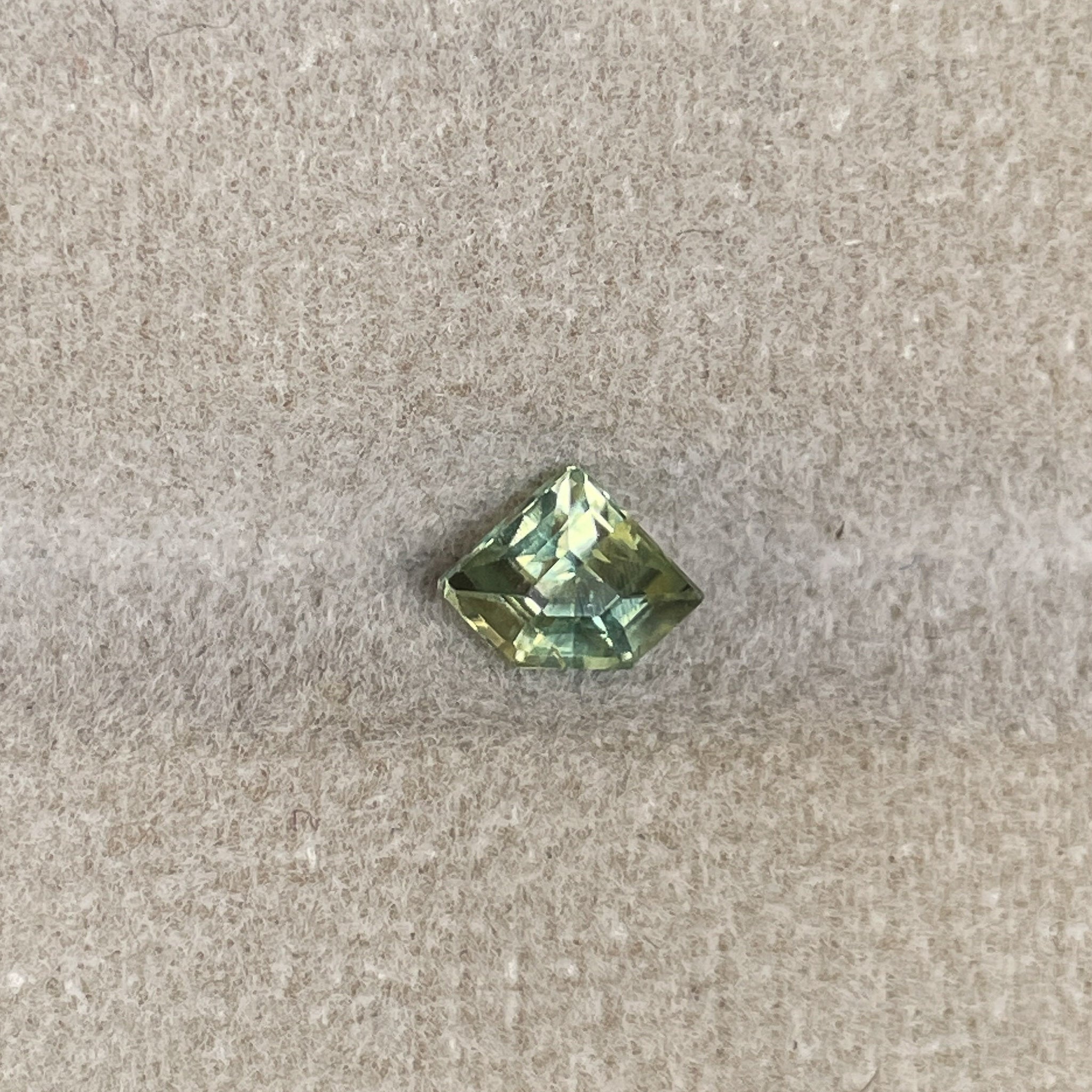 Natural pale green yellow sapphire by NASHGEMS, 0.72 Ct teal shield cut loose sapphire for jewelry or engagement rings.