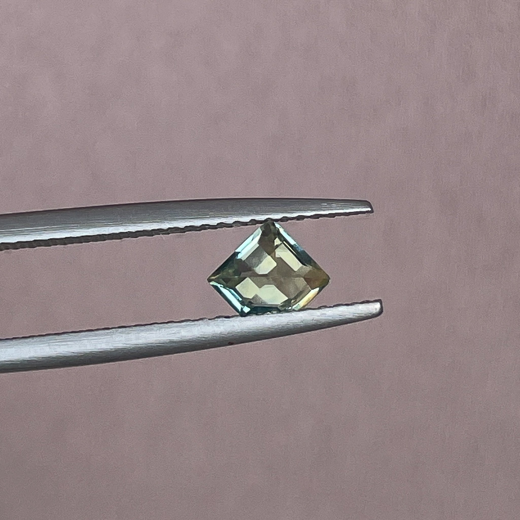 Natural pale green-yellow teal sapphire, 0.72 Ct shield cut, loose no-heat gemstone by NASHGEMS for engagement or custom jewelry.