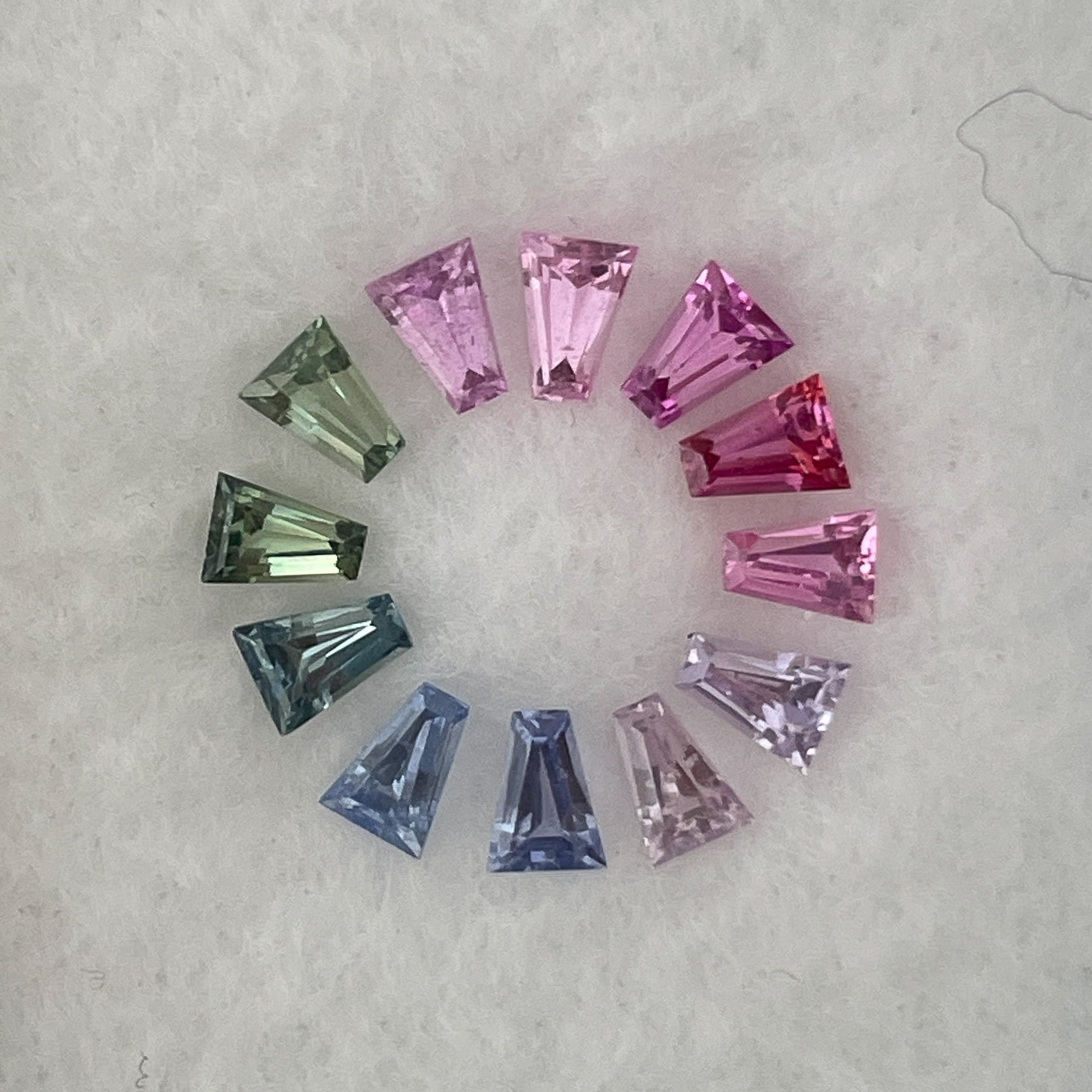 Multi-colored rainbow sapphire lot weighing 1.37 carats, featuring loose sapphires ideal for custom jewelry from NASHGEMS.