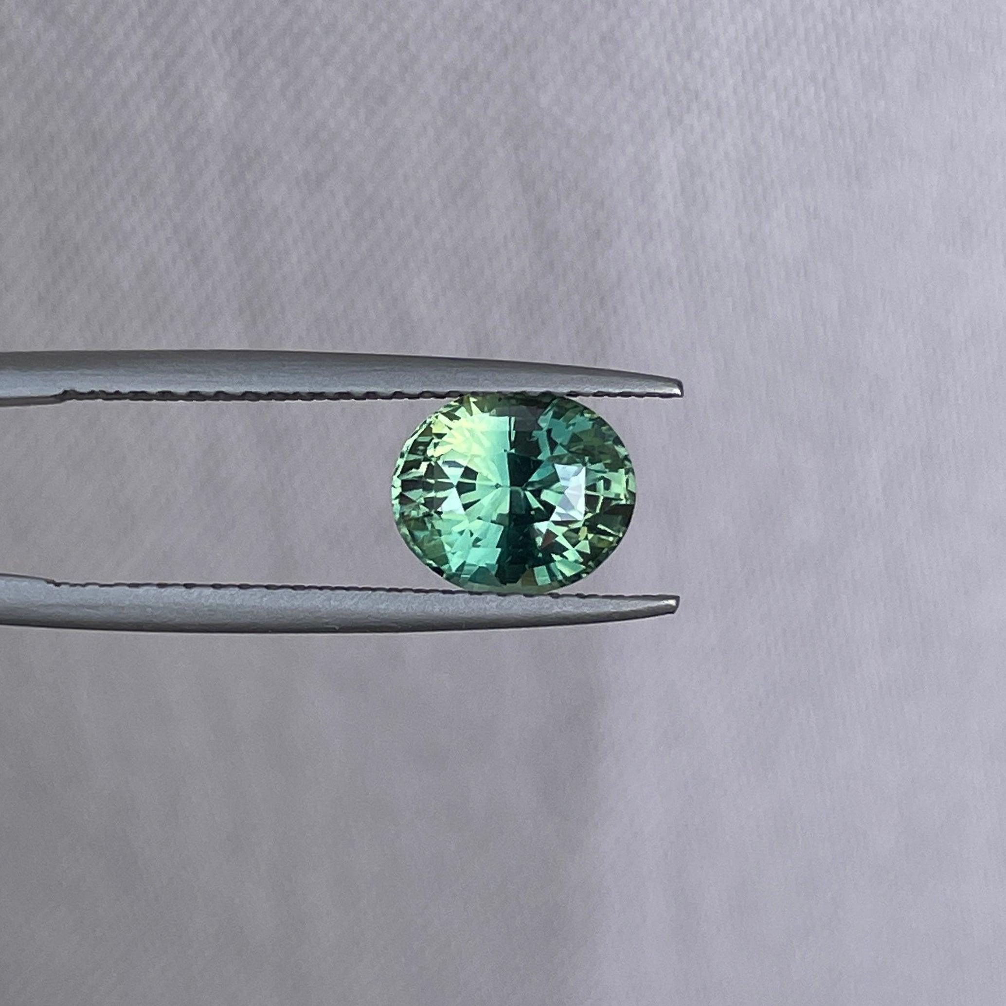 teal blue green parti sapphire oval cut gem