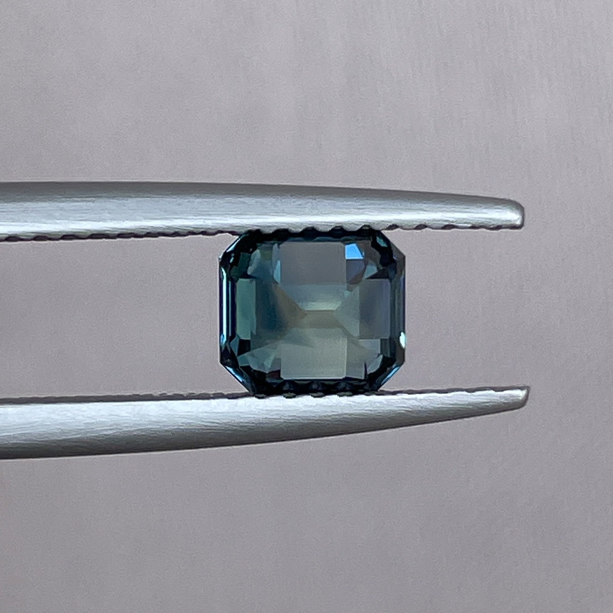 Natural teal green sapphire 1.36 ct emerald cut from NASHGEMS, showcasing vibrant color and clarity for engagement or custom jewelry.