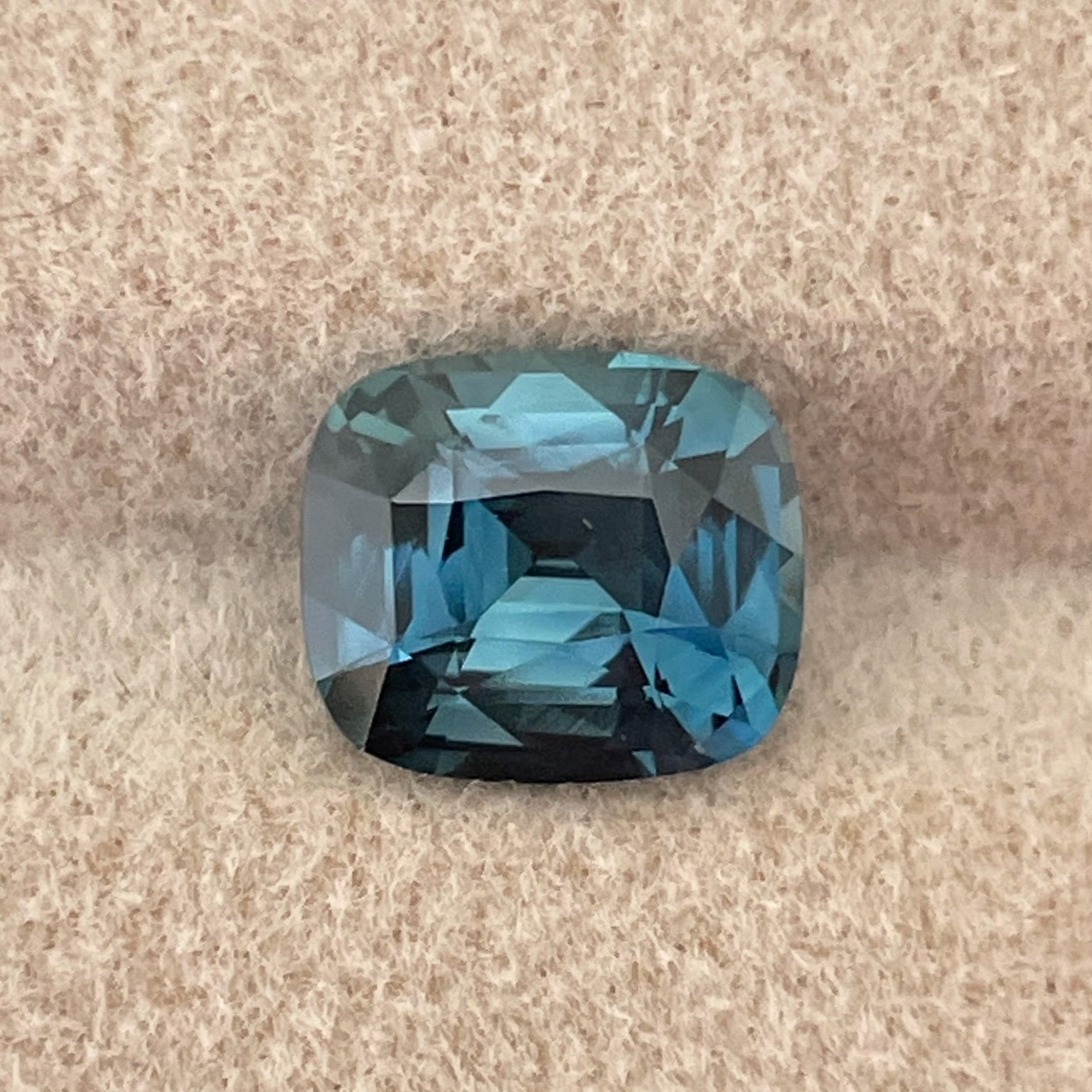 Teal blue sapphire loose gemstone, 2.52 ct cushion cut, heat treated, ideal for engagement rings or custom jewelry.
