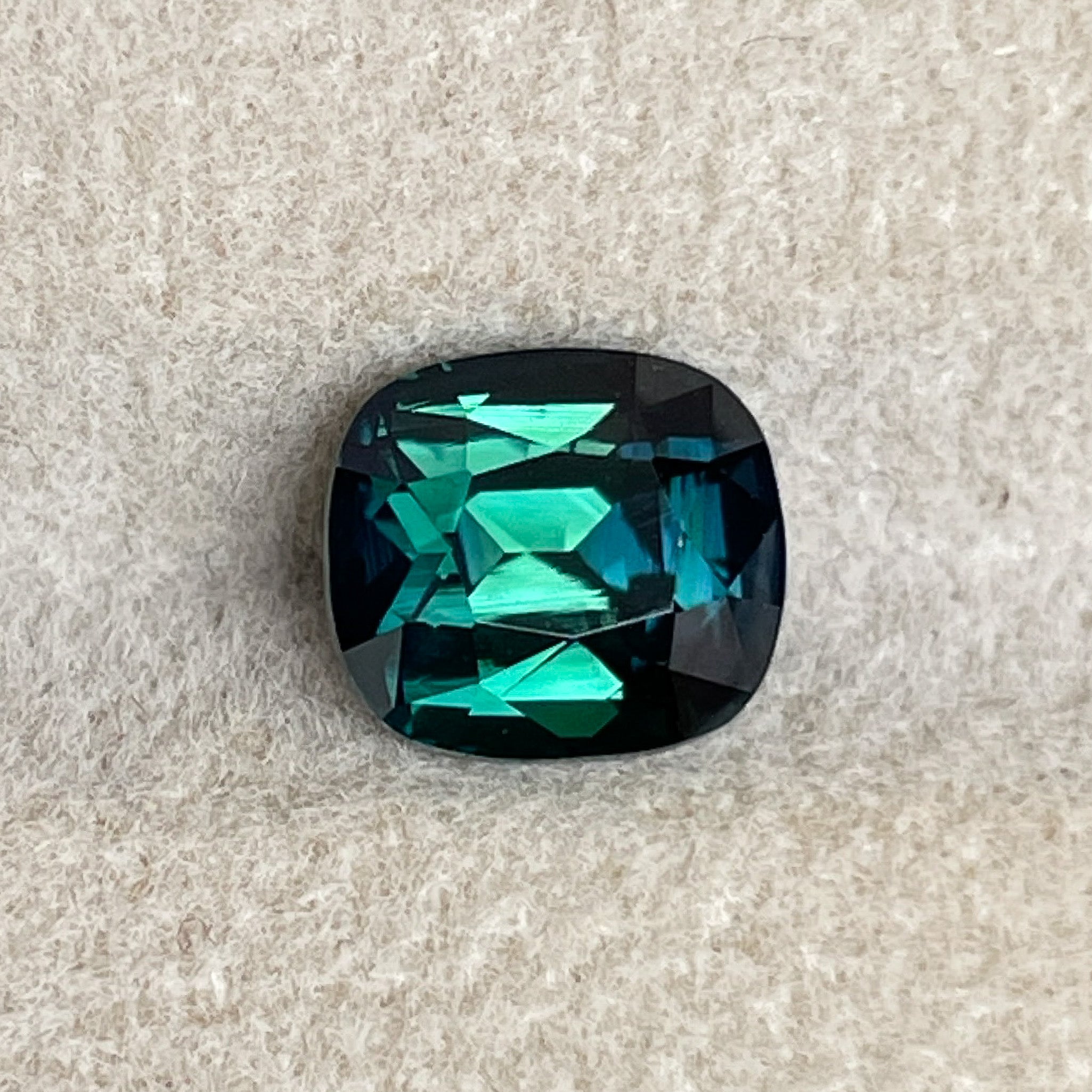 Natural forest green sapphire, 2.56 Ct cushion cut teal blue-green loose gemstone by NASHGEMS, ideal for jewelry or engagement rings.