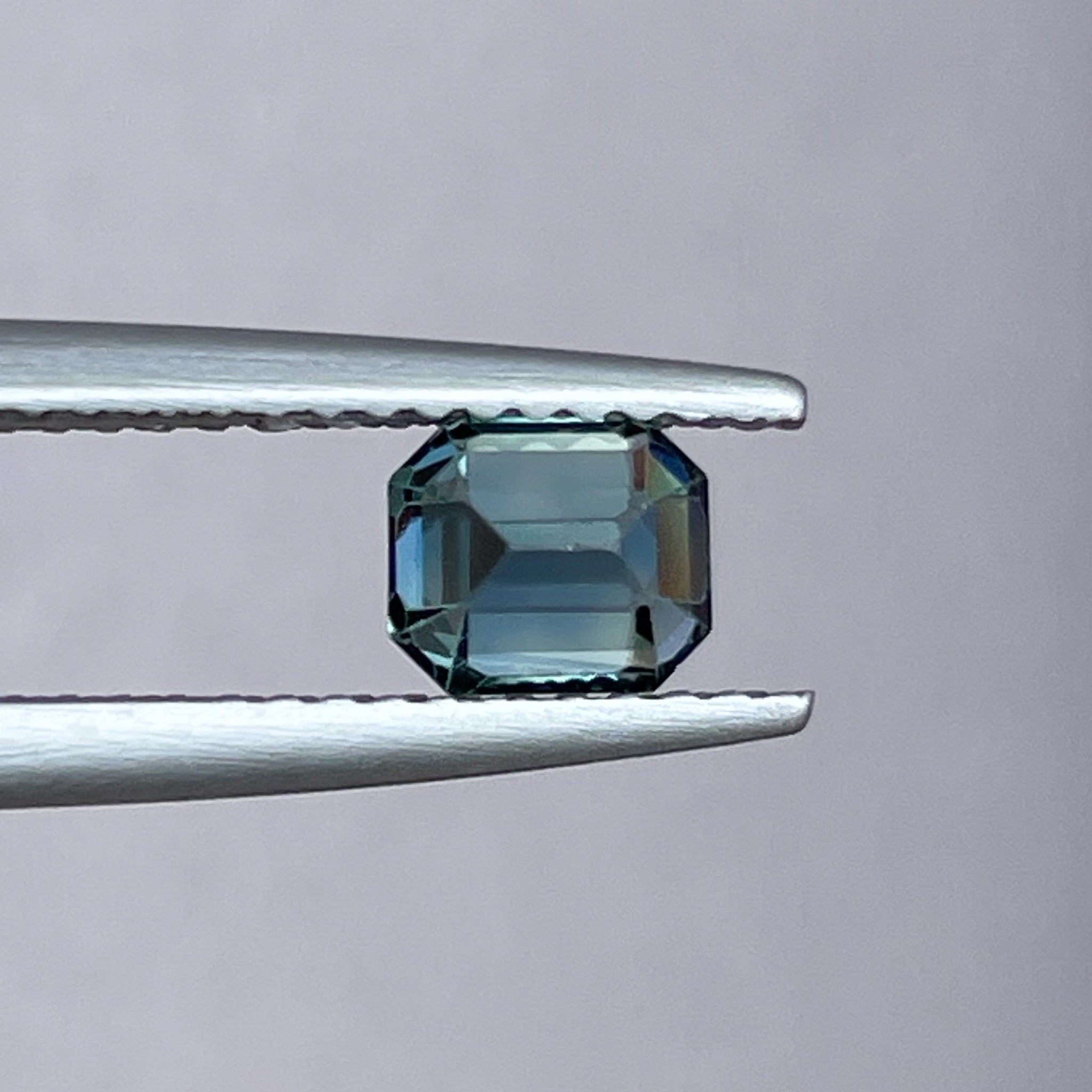 Natural teal blue sapphire 1.00 carat emerald cut loose gemstone from NASHGEMS, ideal for engagement rings or custom jewelry.