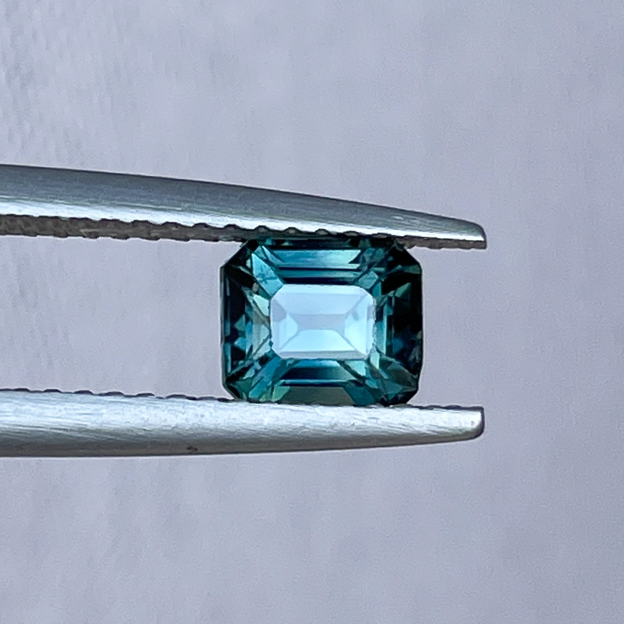 Natural teal blue sapphire 1.06 Ct emerald cut loose gemstone from NASHGEMS, ideal for engagement rings or custom jewelry.