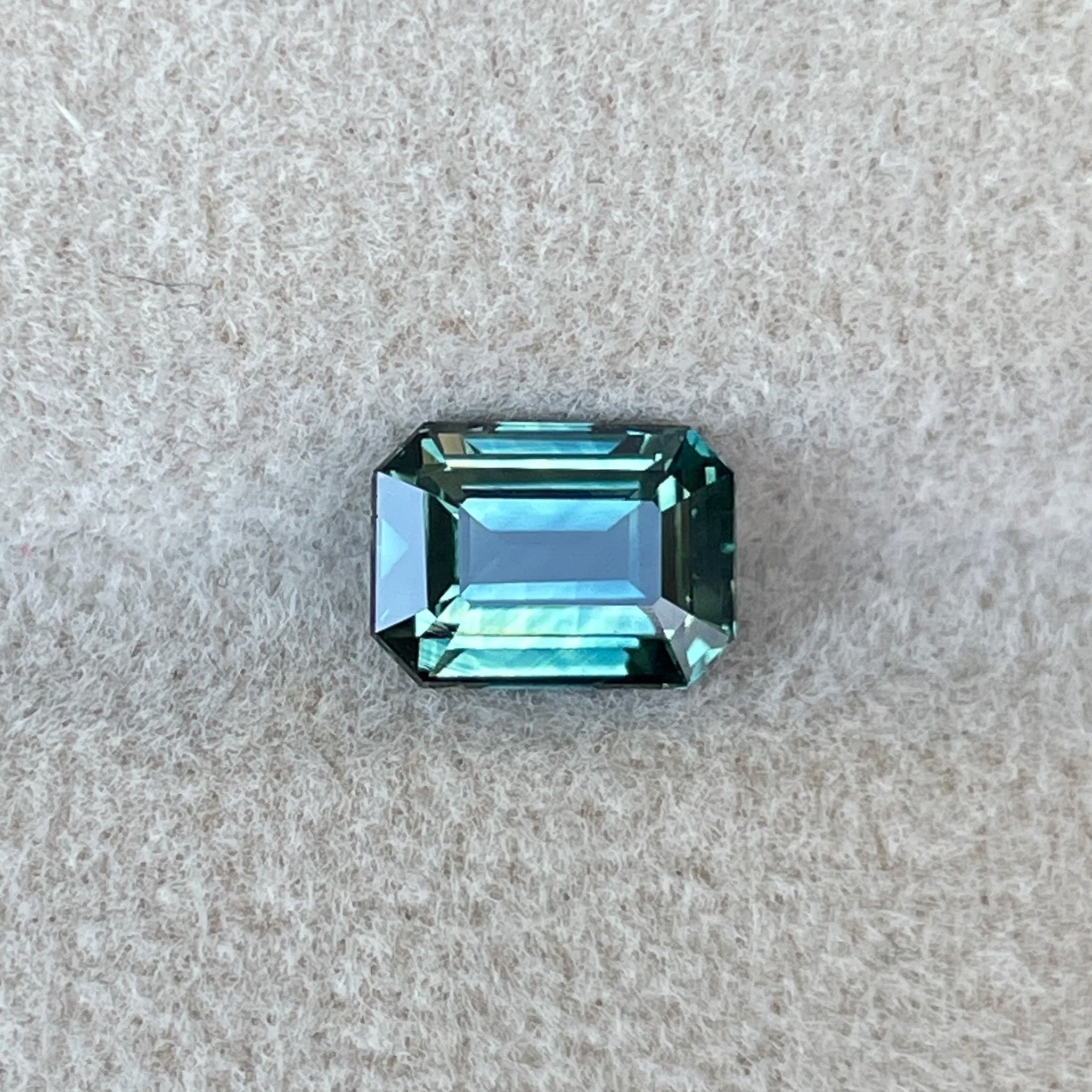 Natural teal sapphire loose gemstone, 1.52 ct emerald cut by NASHGEMS, perfect for engagement rings or custom jewelry.