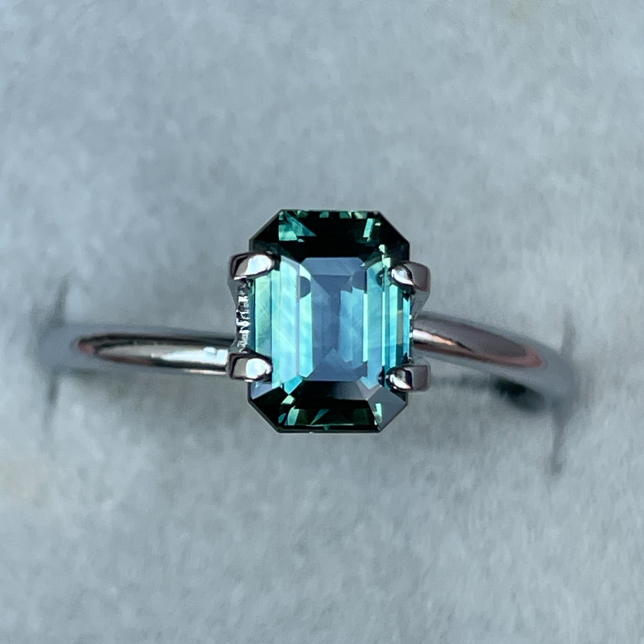 Natural teal blue-green sapphire loose gemstone, 1.52 Ct emerald cut by NASHGEMS, ideal for engagement rings or custom jewelry.