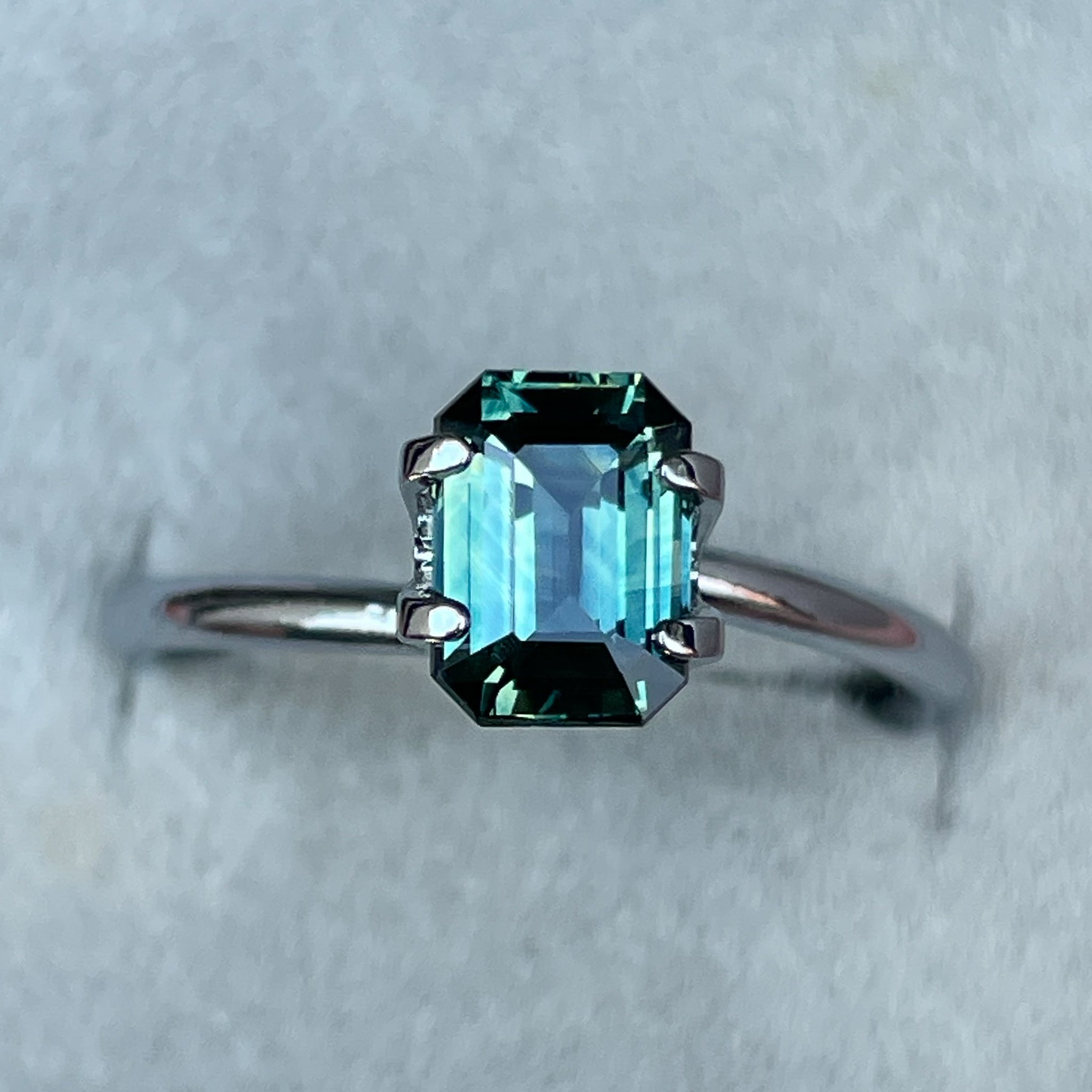 Natural teal sapphire loose stone, 1.52 Ct emerald cut by NASHGEMS, ideal for engagement rings or custom jewelry designs.