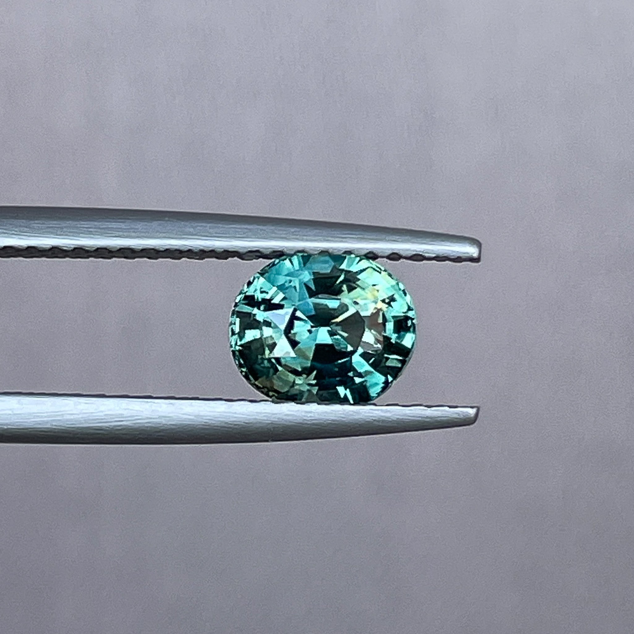 Teal blue-green oval cut sapphire, 1.56 Ct, loose gemstone by NASHGEMS for engagement or custom jewelry designs.