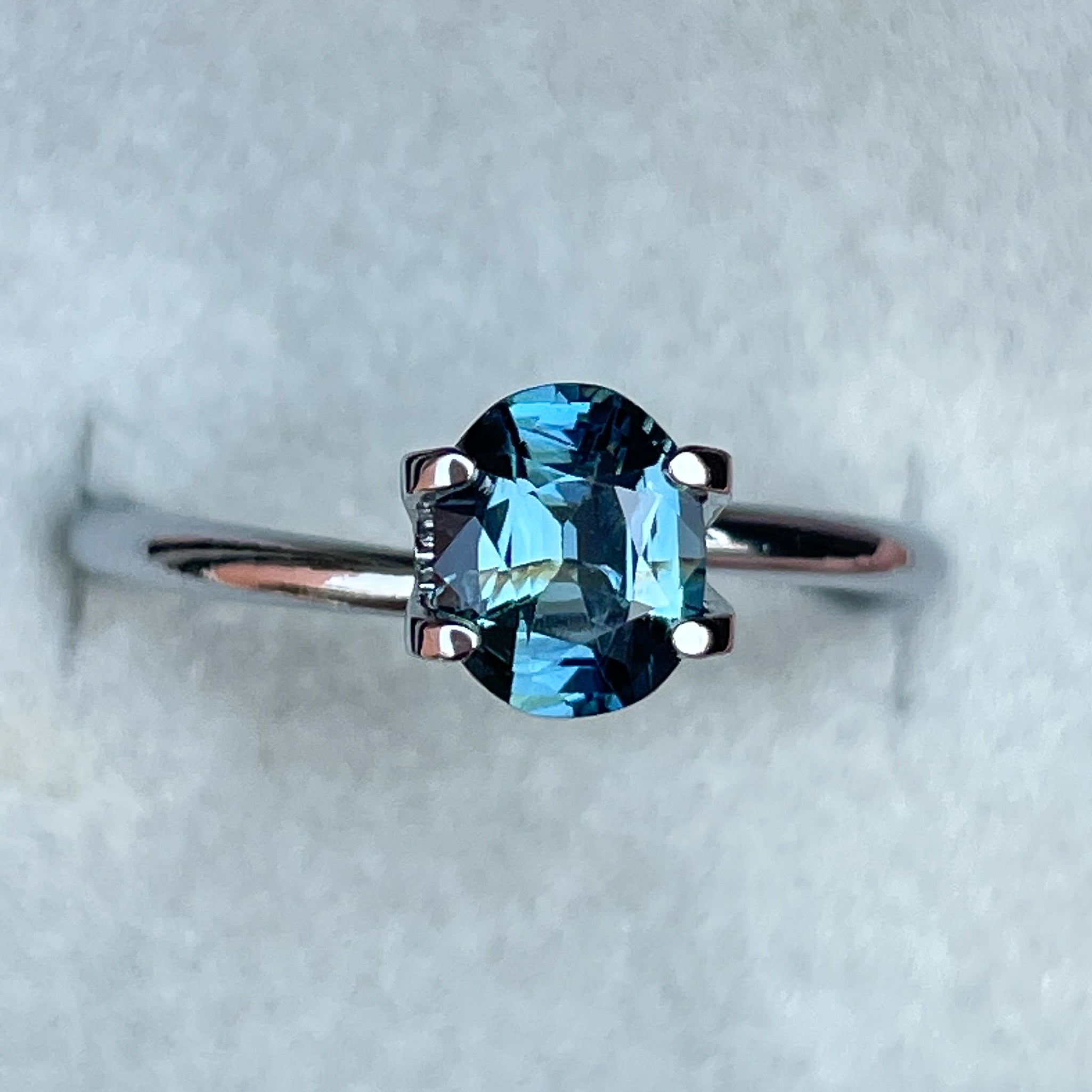 Natural teal sapphire loose stone, 1.03 Ct oval cut by NASHGEMS, perfect for engagement rings or custom jewelry.