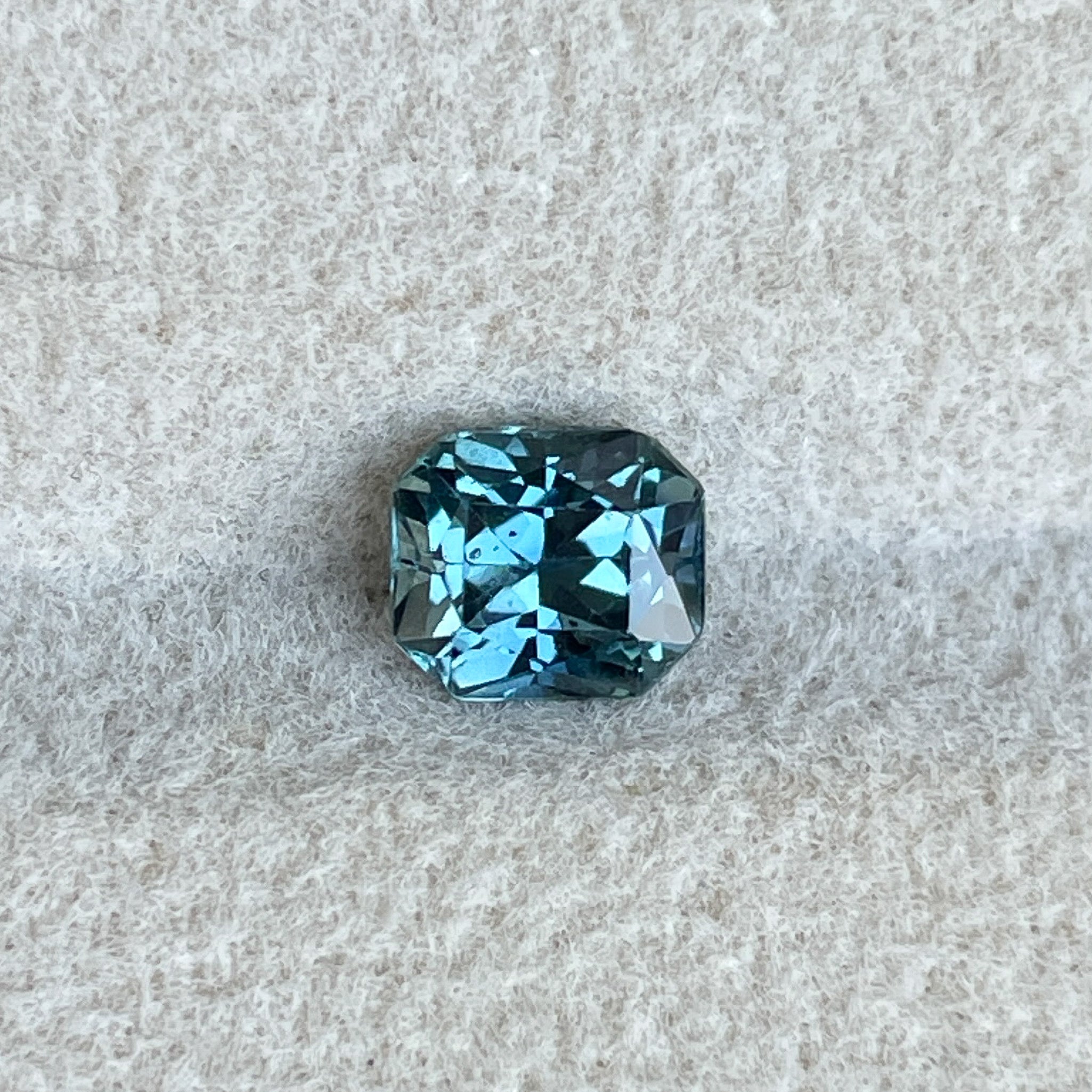 Natural teal blue sapphire 0.98 Ct radiant cut loose gemstone by NASHGEMS, perfect for engagement rings or custom jewelry.
